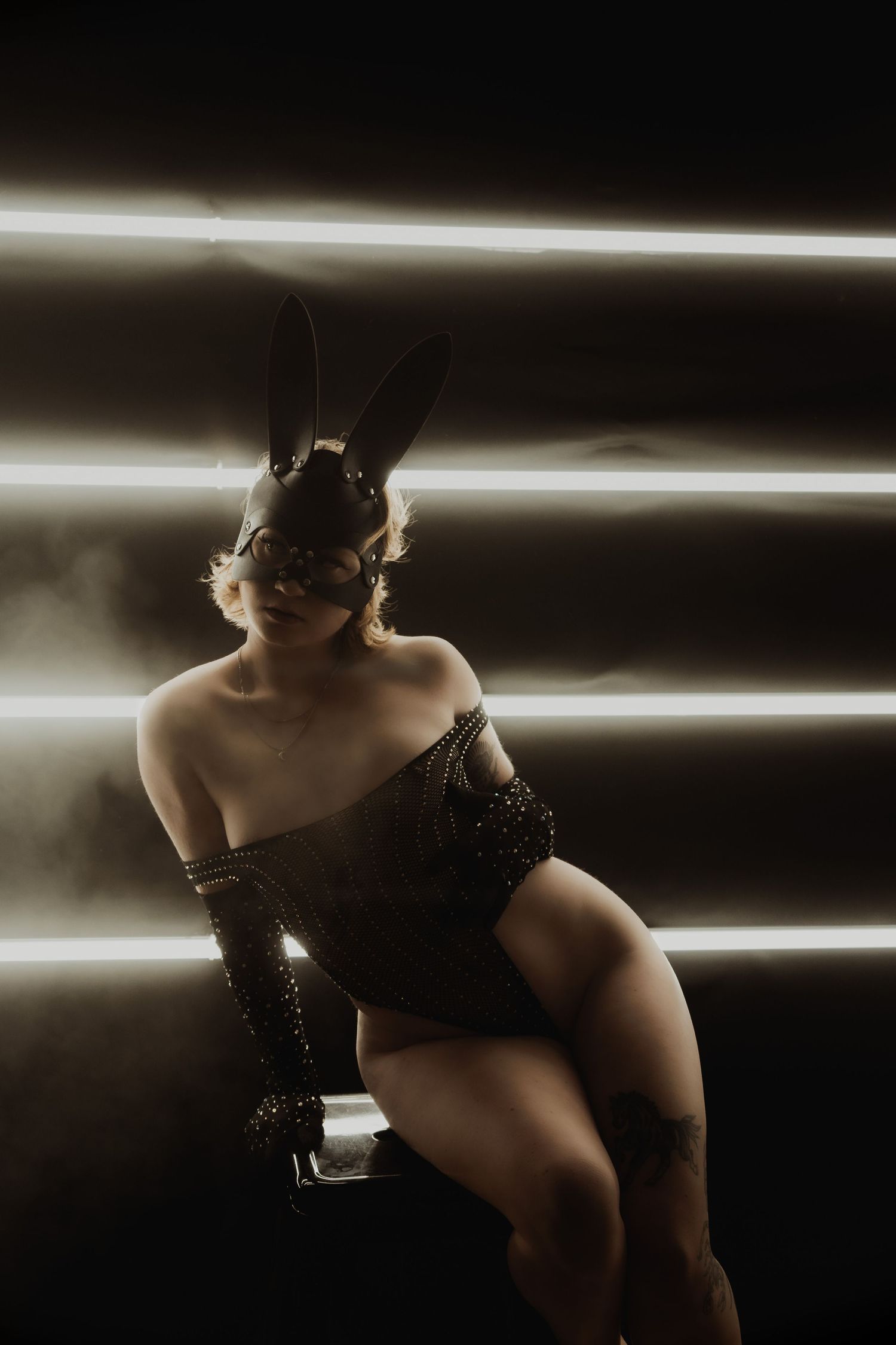 Inclusive boudoir photography session in Grand Rapids featuring a confident woman in a body-positive studio environment
