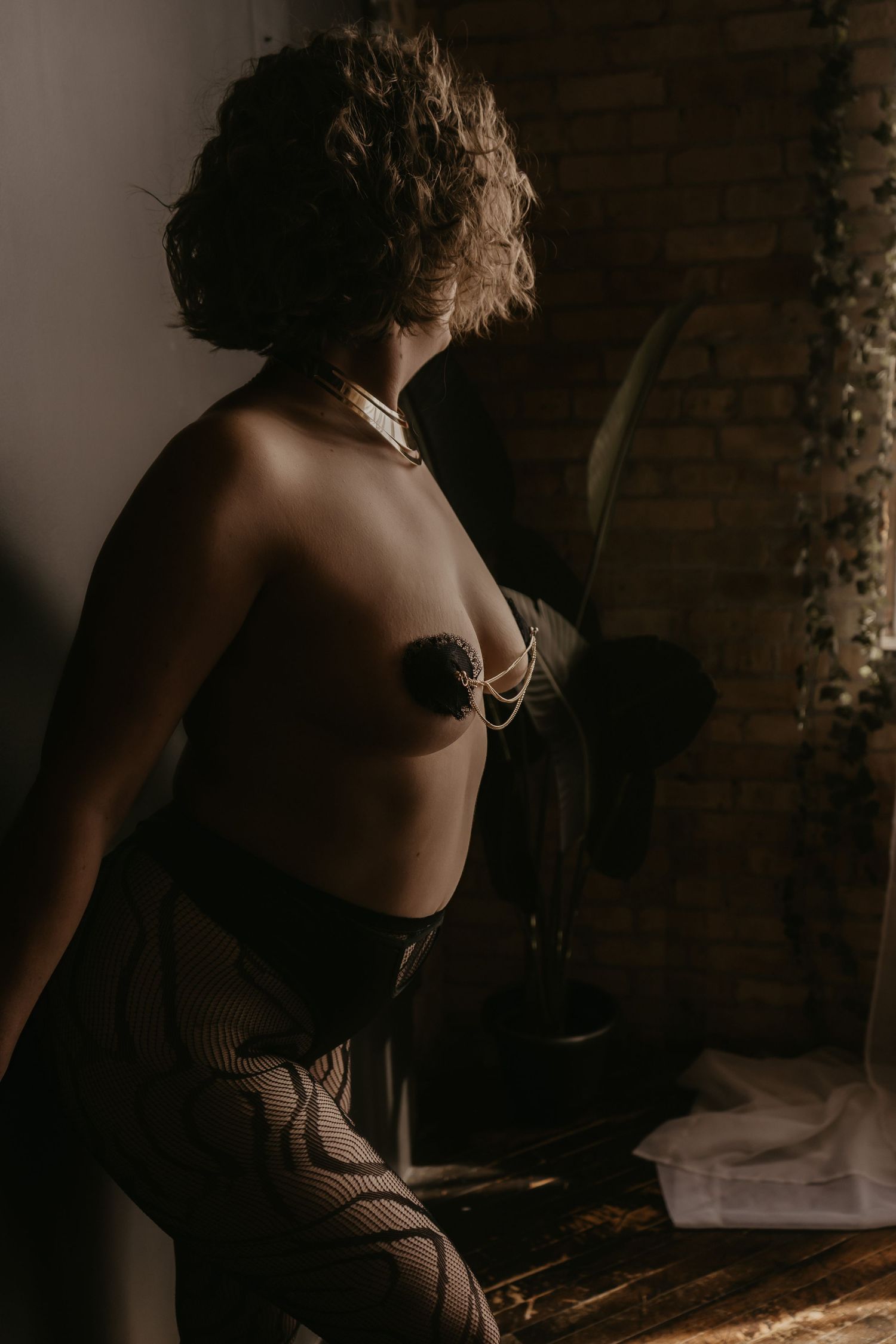 Inclusive boudoir photography session in Grand Rapids featuring a confident woman in a body-positive studio environment