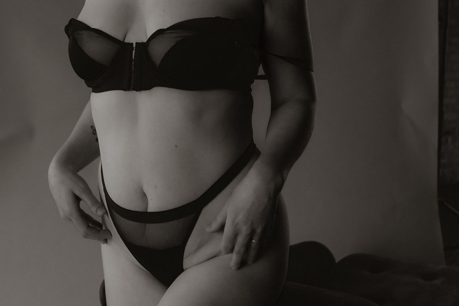 Inclusive boudoir photography session in Grand Rapids featuring a confident woman in a body-positive studio environment