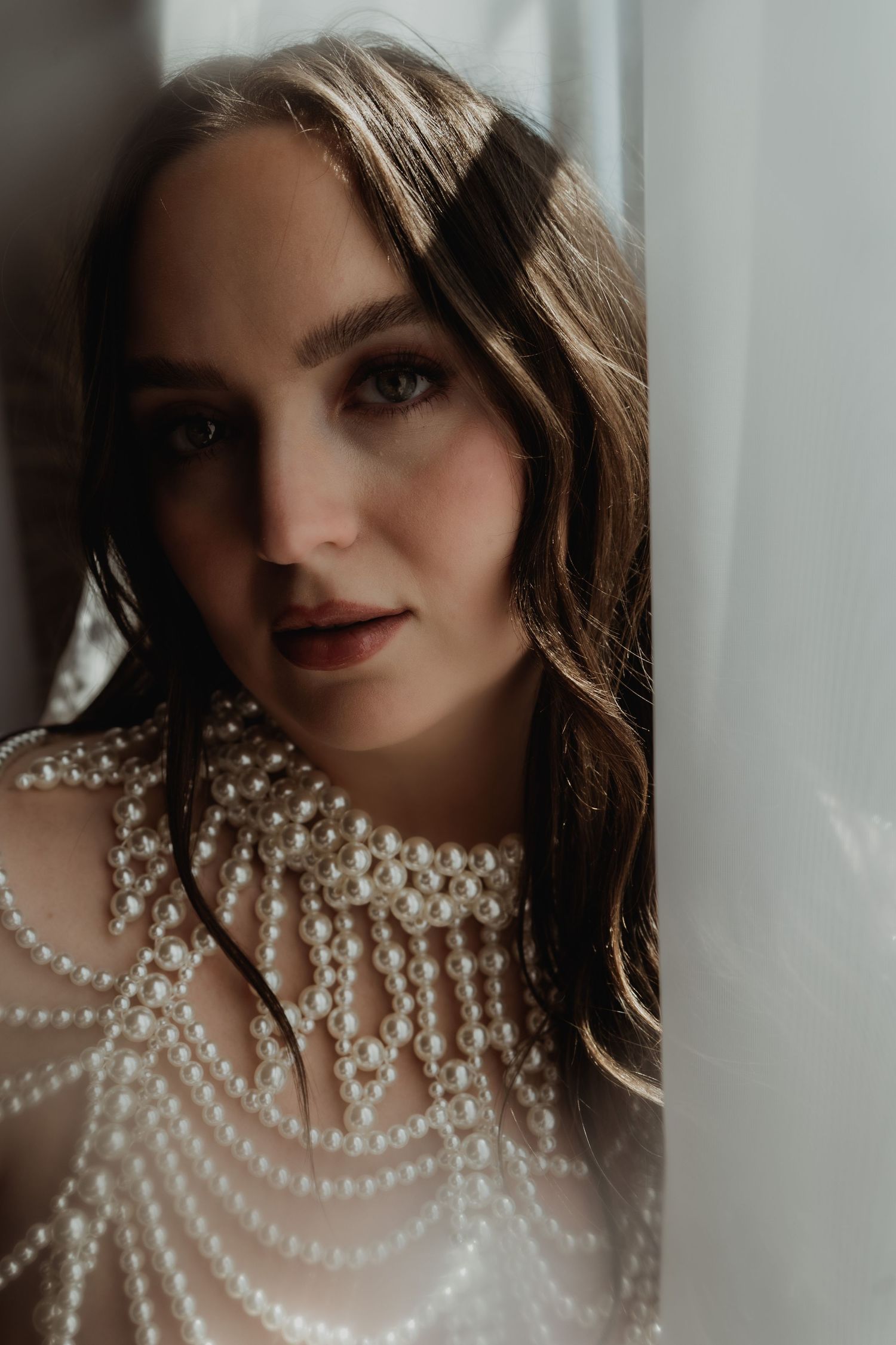 Inclusive boudoir photography session in Grand Rapids featuring a confident woman in a body-positive studio environment