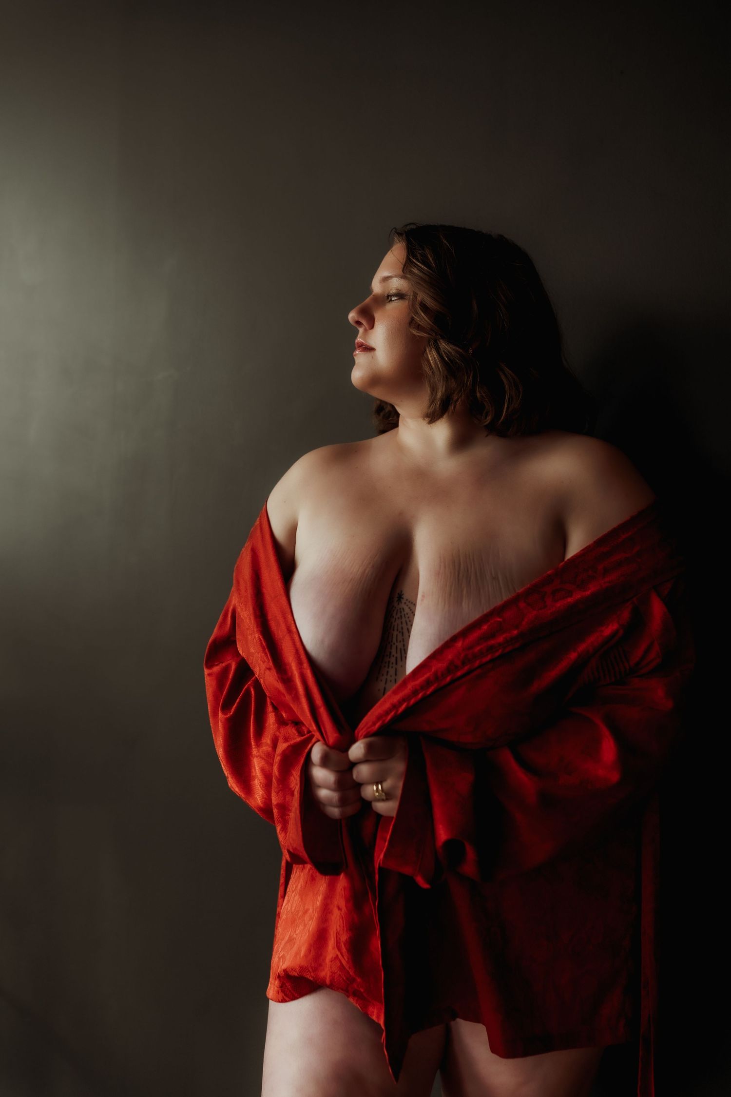 Inclusive boudoir photography session in Grand Rapids featuring a confident woman in a body-positive studio environment