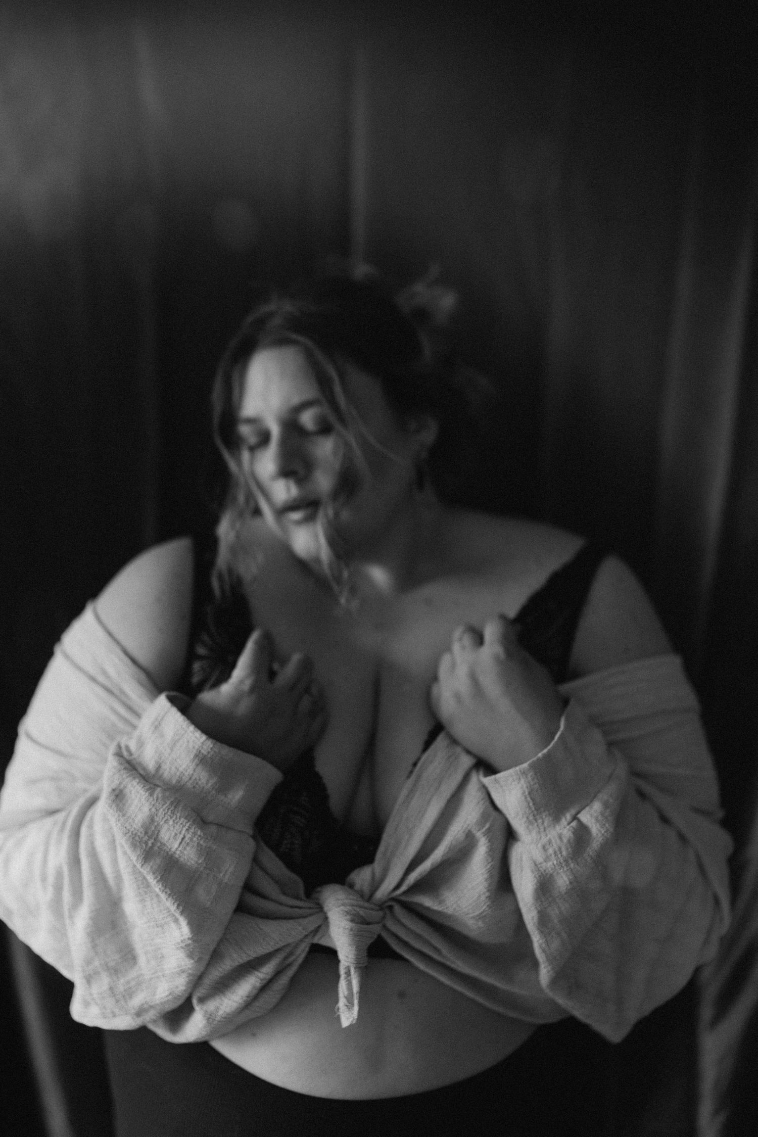 Inclusive boudoir photography session in Grand Rapids featuring a confident woman in a body-positive studio environment