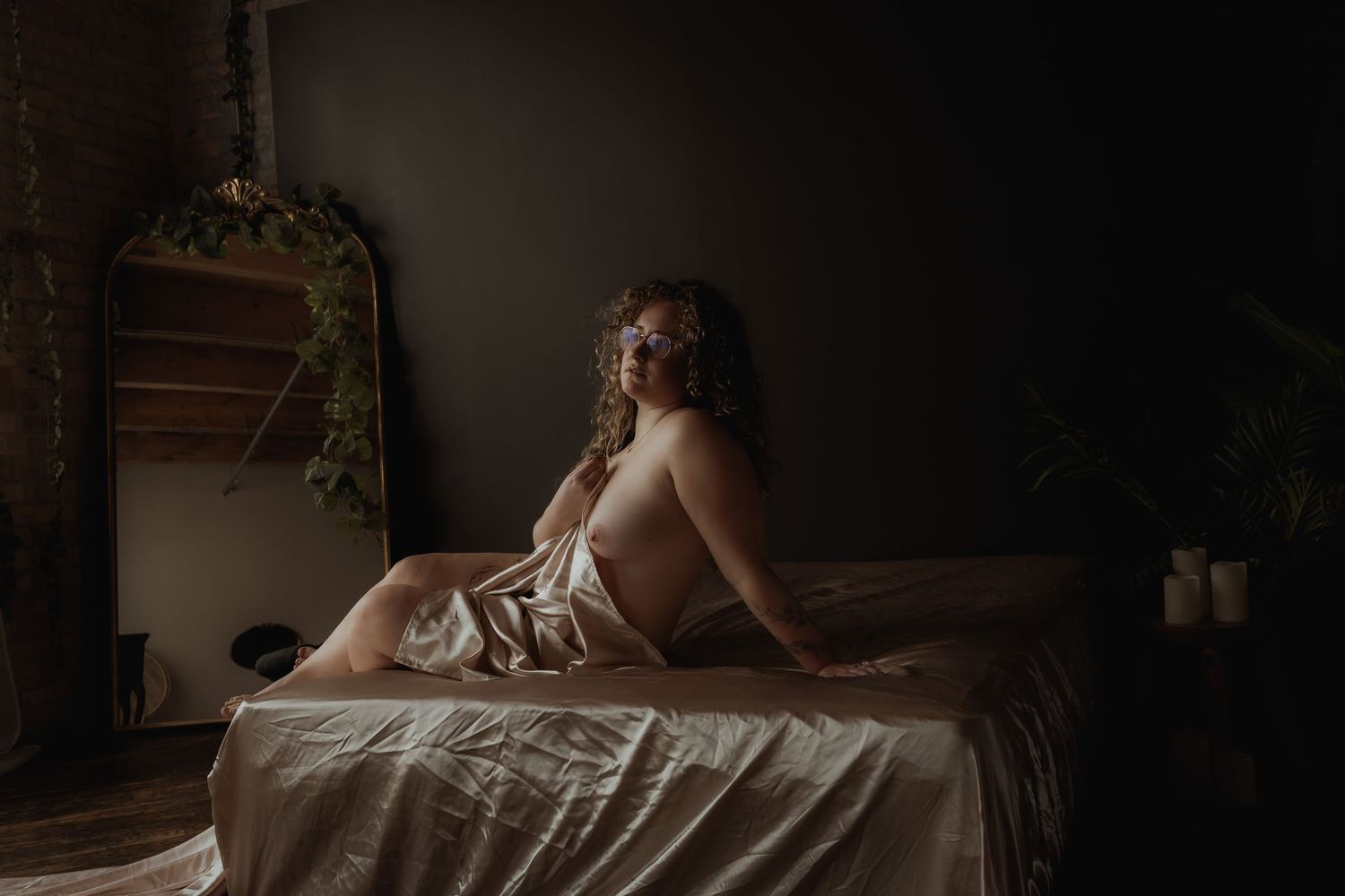 Inclusive boudoir photography session in Grand Rapids featuring a confident woman in a body-positive studio environment