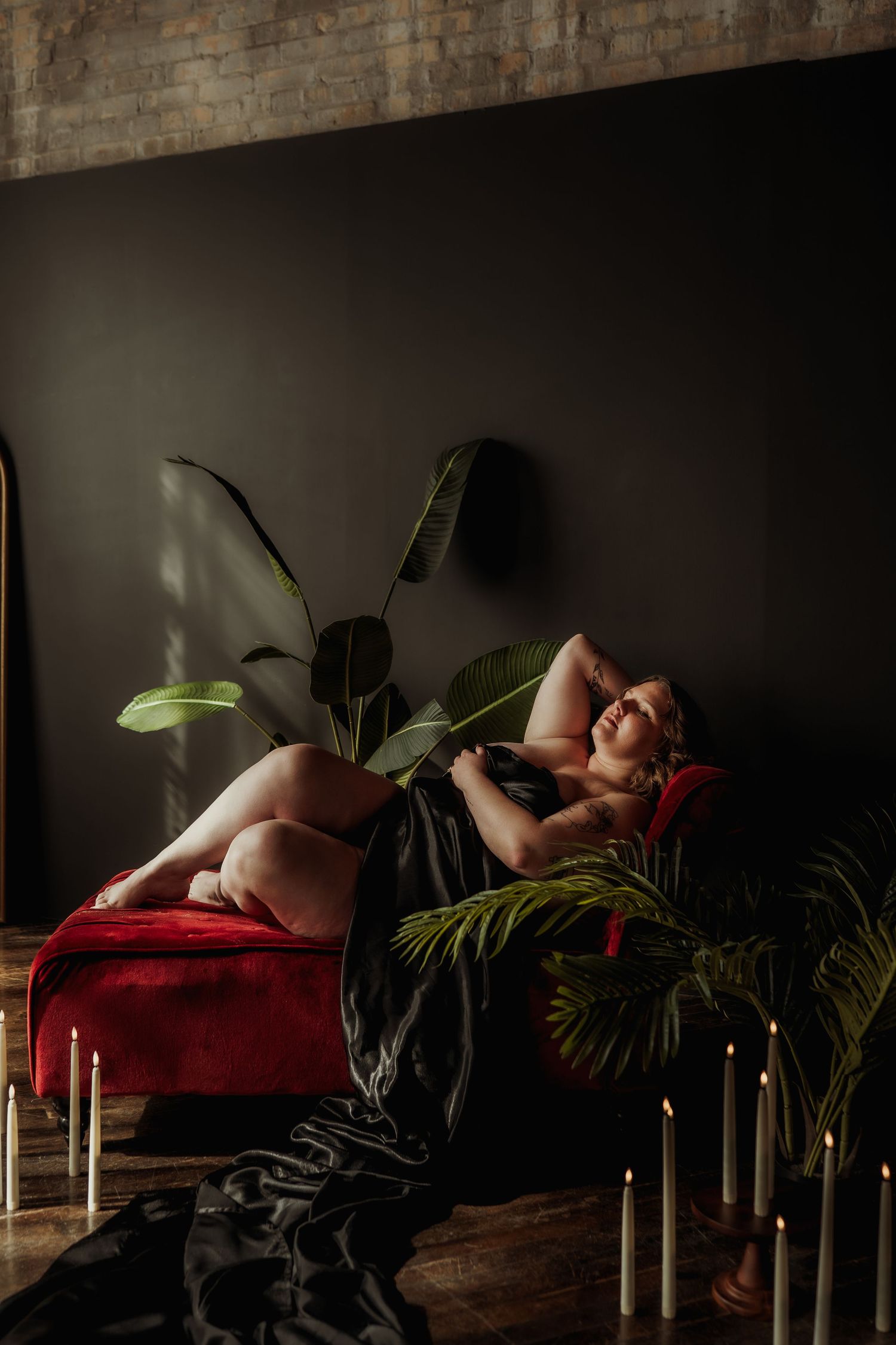 Inclusive boudoir photography session in Grand Rapids featuring a confident woman in a body-positive studio environment