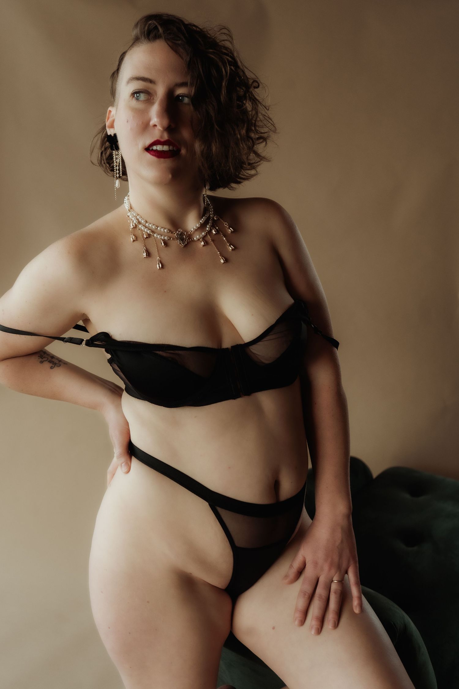 Inclusive boudoir photography session in Grand Rapids featuring a confident woman in a body-positive studio environment