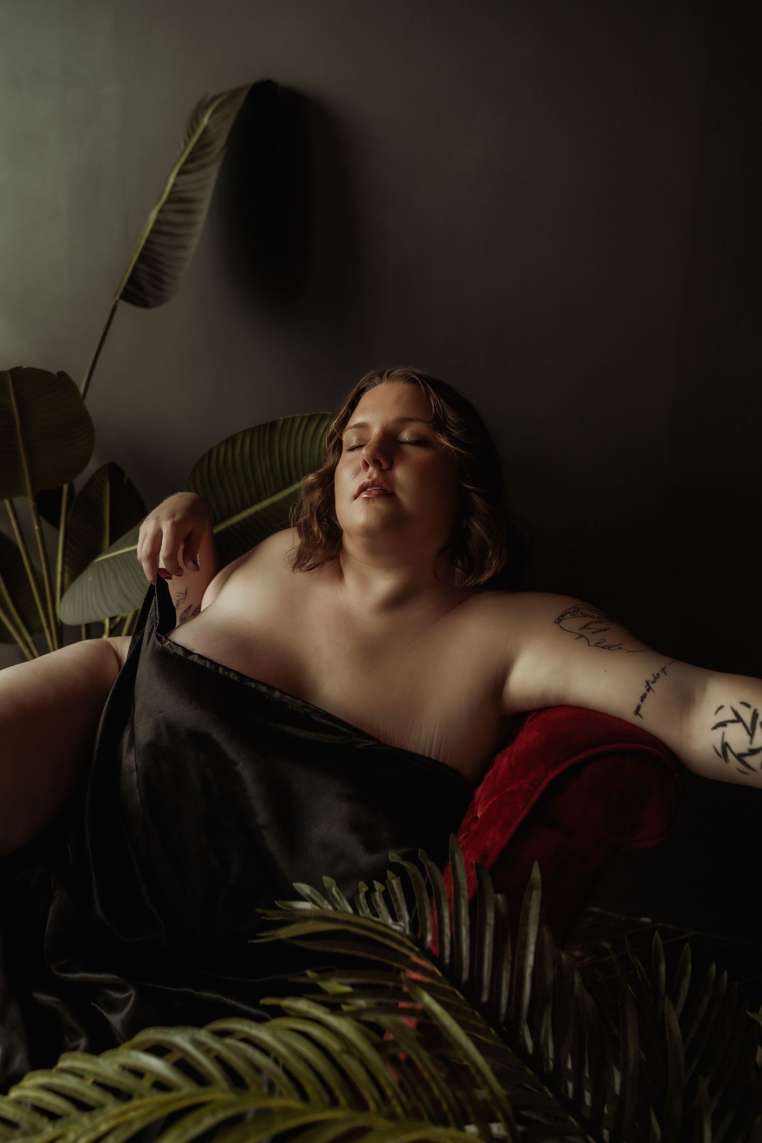 Inclusive boudoir photography session in Grand Rapids featuring a confident woman in a body-positive studio environment