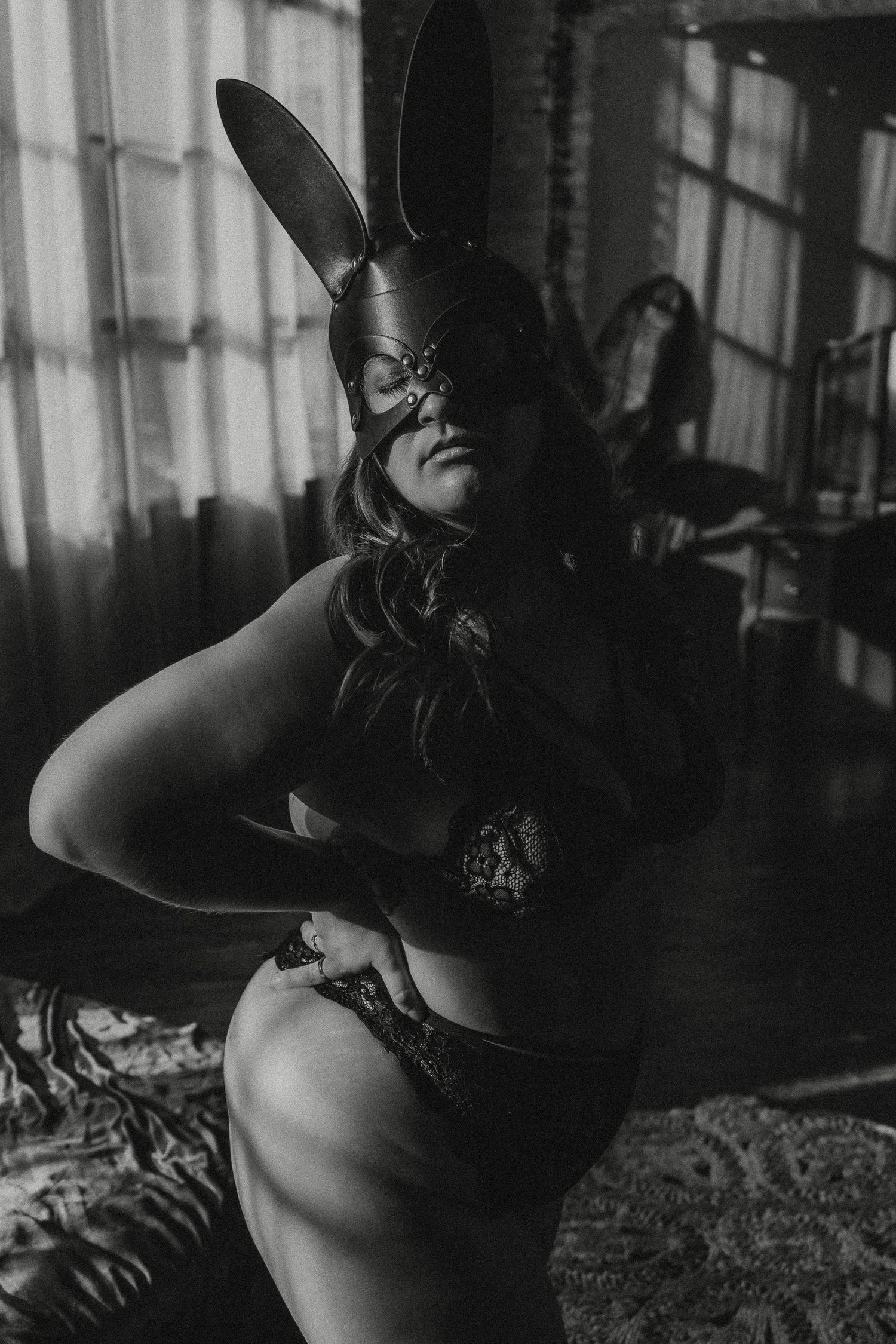 Inclusive boudoir photography session in Grand Rapids featuring a confident woman in a body-positive studio environment