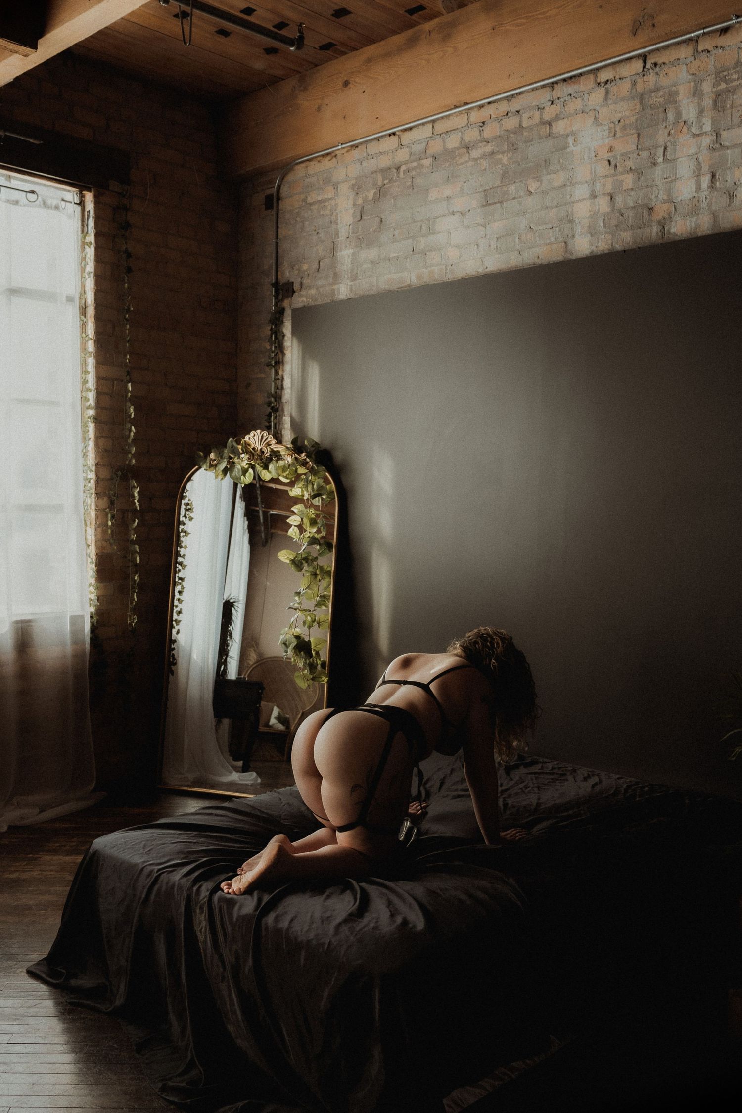 Inclusive boudoir photography session in Grand Rapids featuring a confident woman in a body-positive studio environment