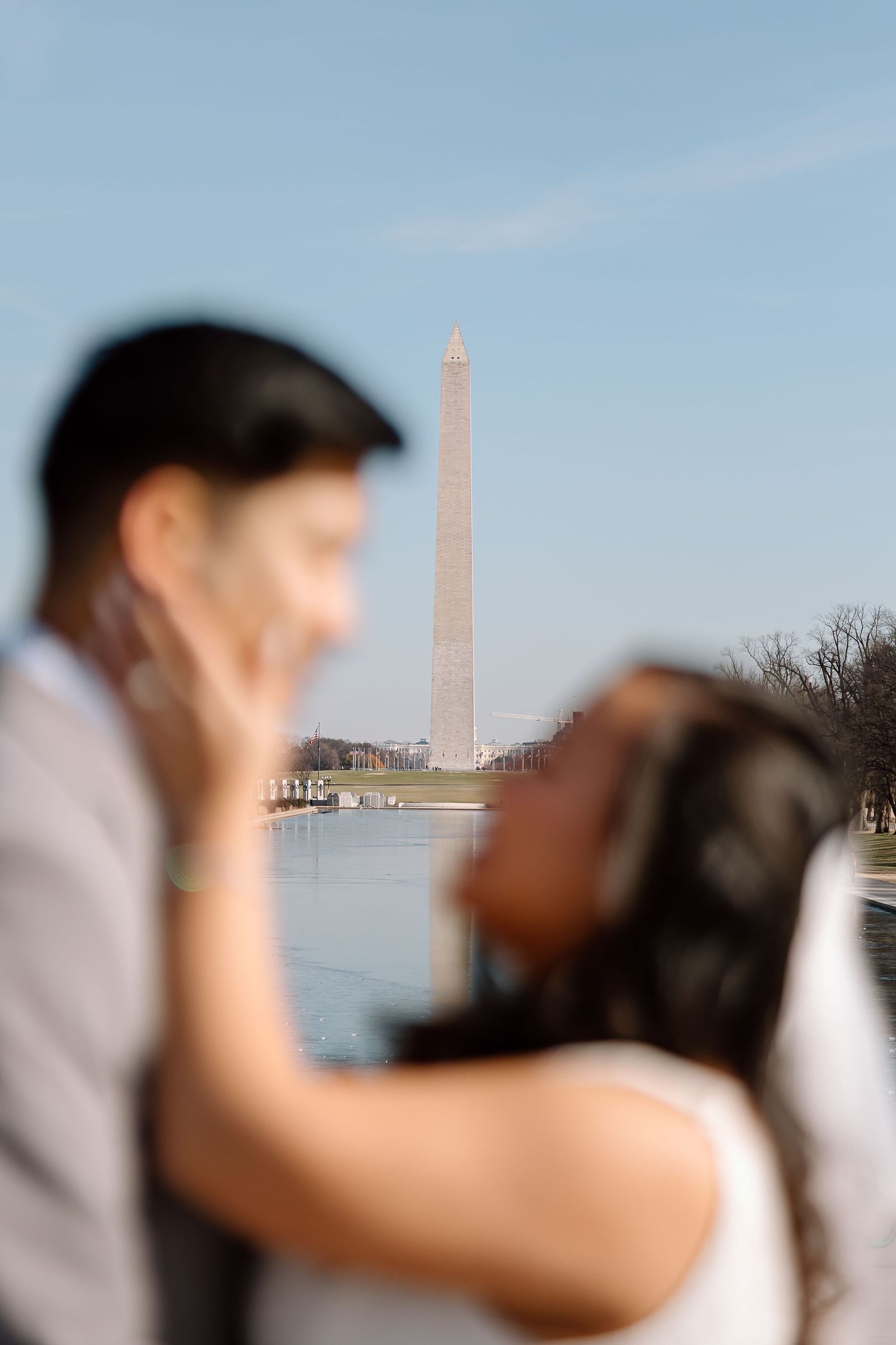 Editorial-style wedding portrait with the Washington Monument behind the couple