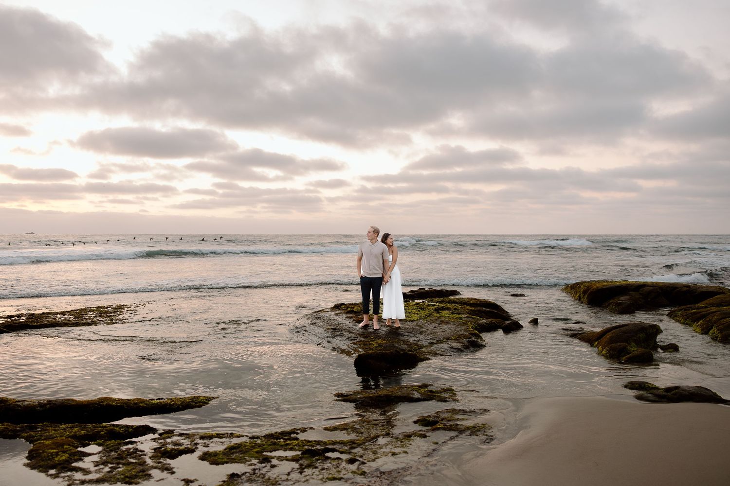 Couple walking the quiet shoreline at Assateague Island National Seashore in Maryland.