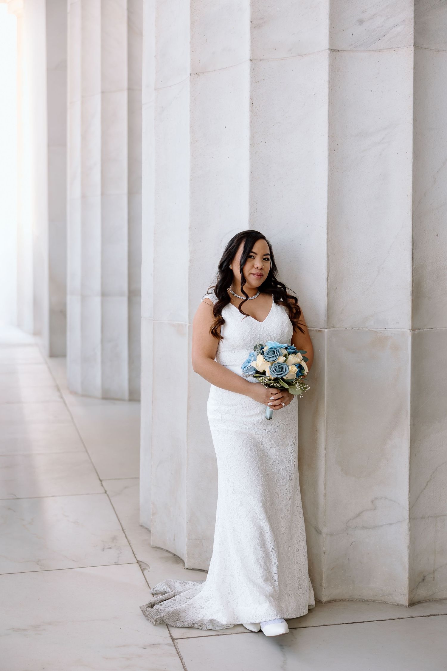 Bride’s veil flowing in the wind during an editorial elopement portrait at the National Mall.