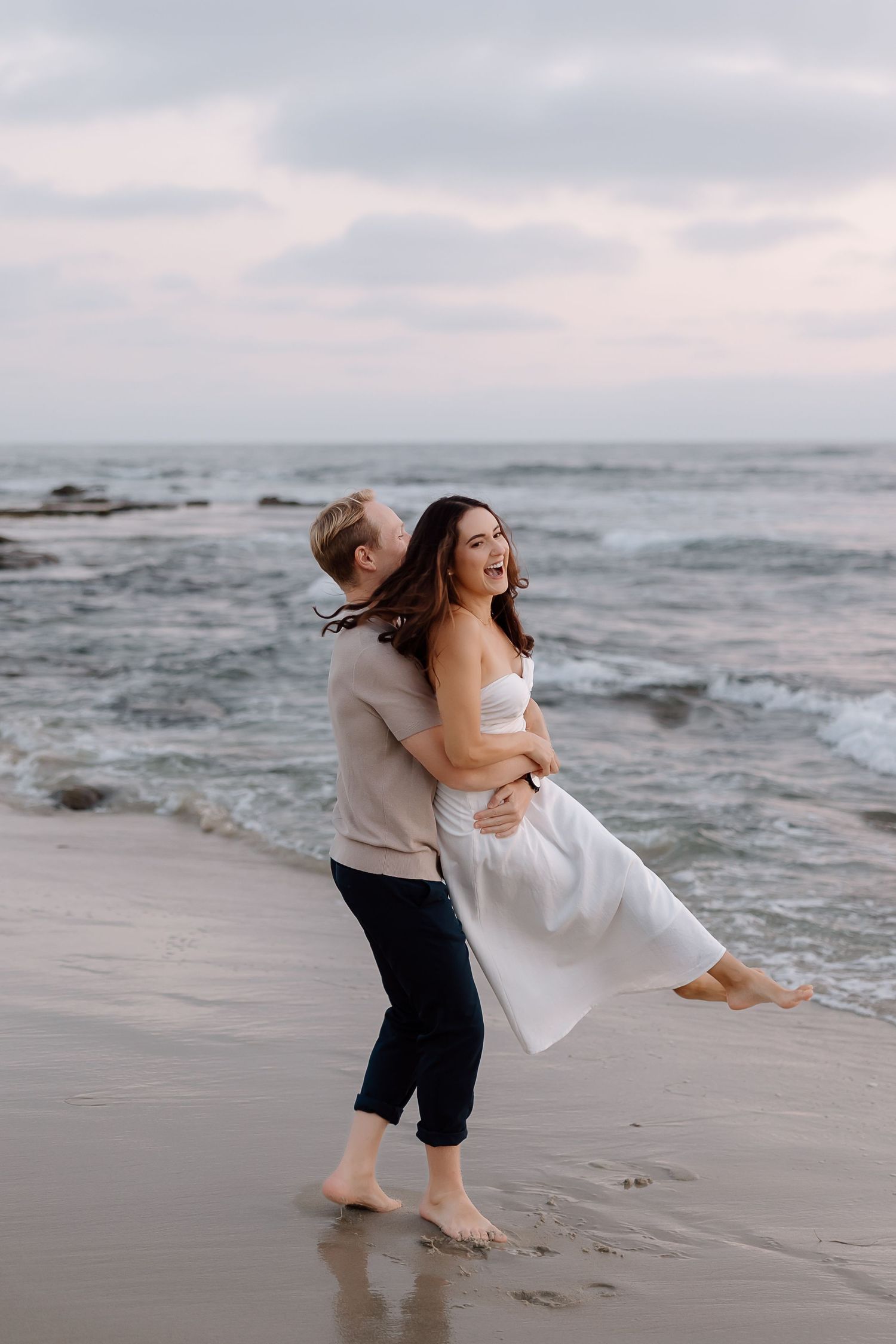Candid couple walking the quiet beach at Point Lookout State Park, Southern Maryland