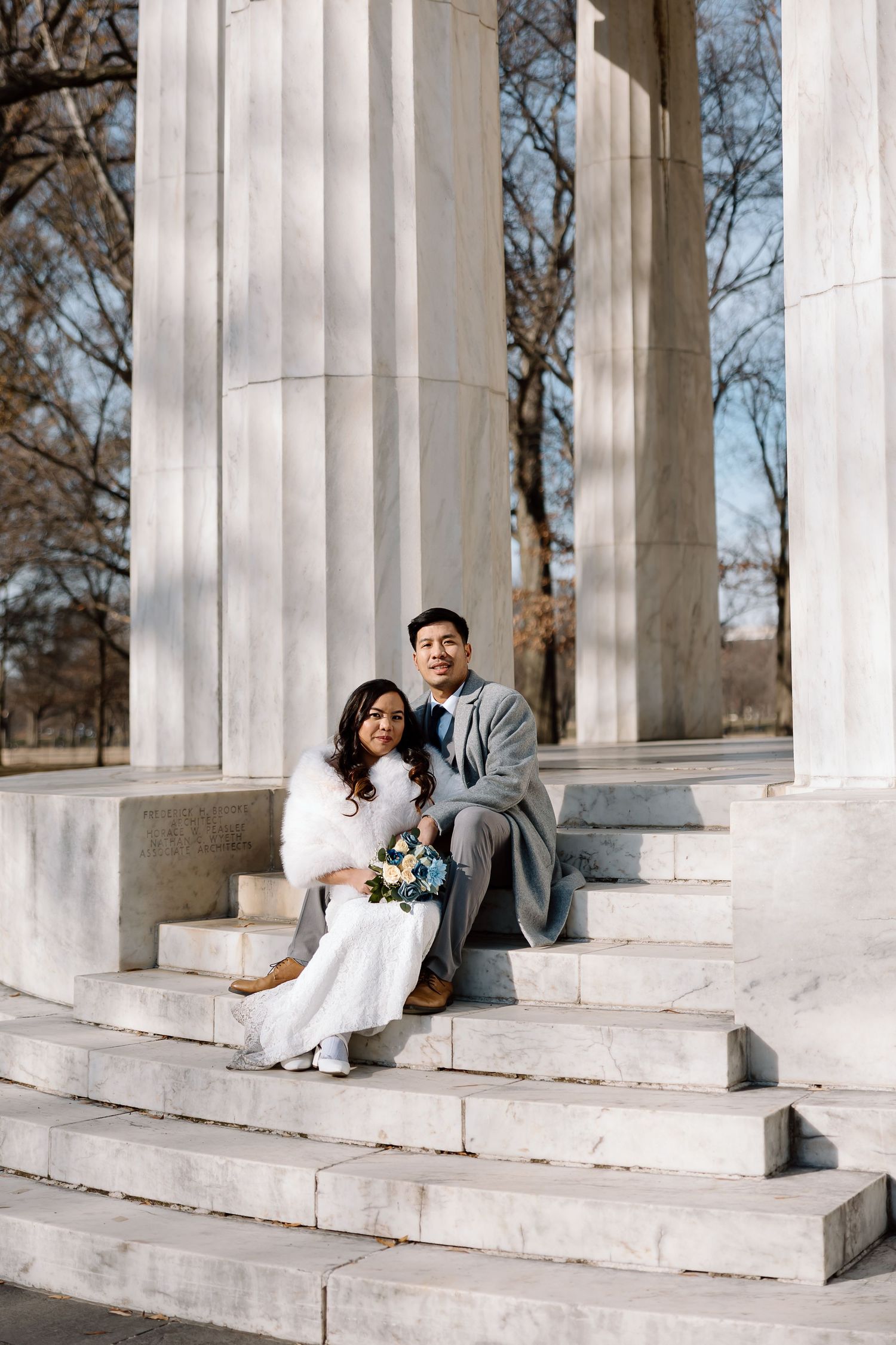 Candid newlywed moment captured at the DC War Memorial during a National Mall elopement.