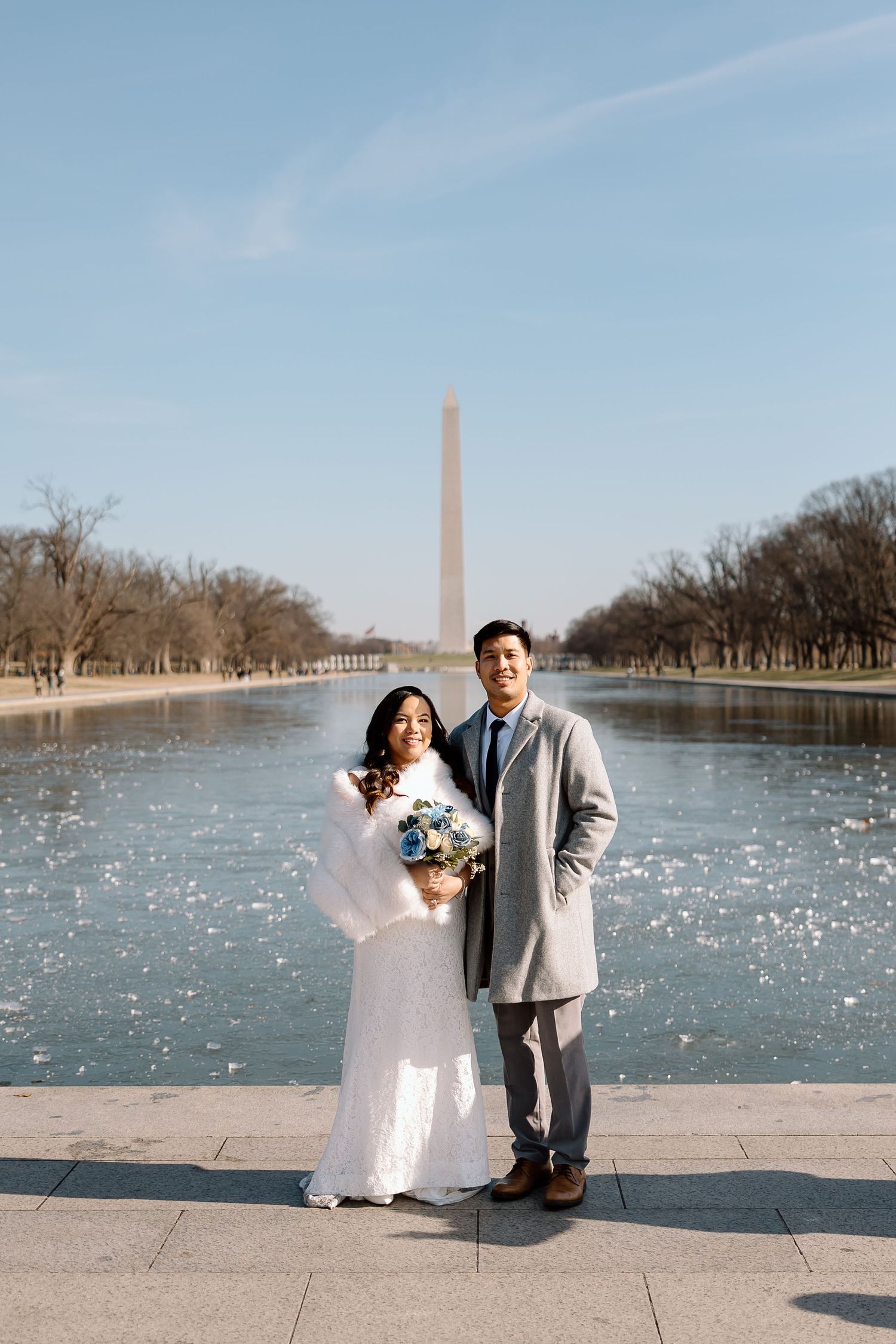 Elopement couple sharing a kiss in front of the Washington Monument at the National Mal