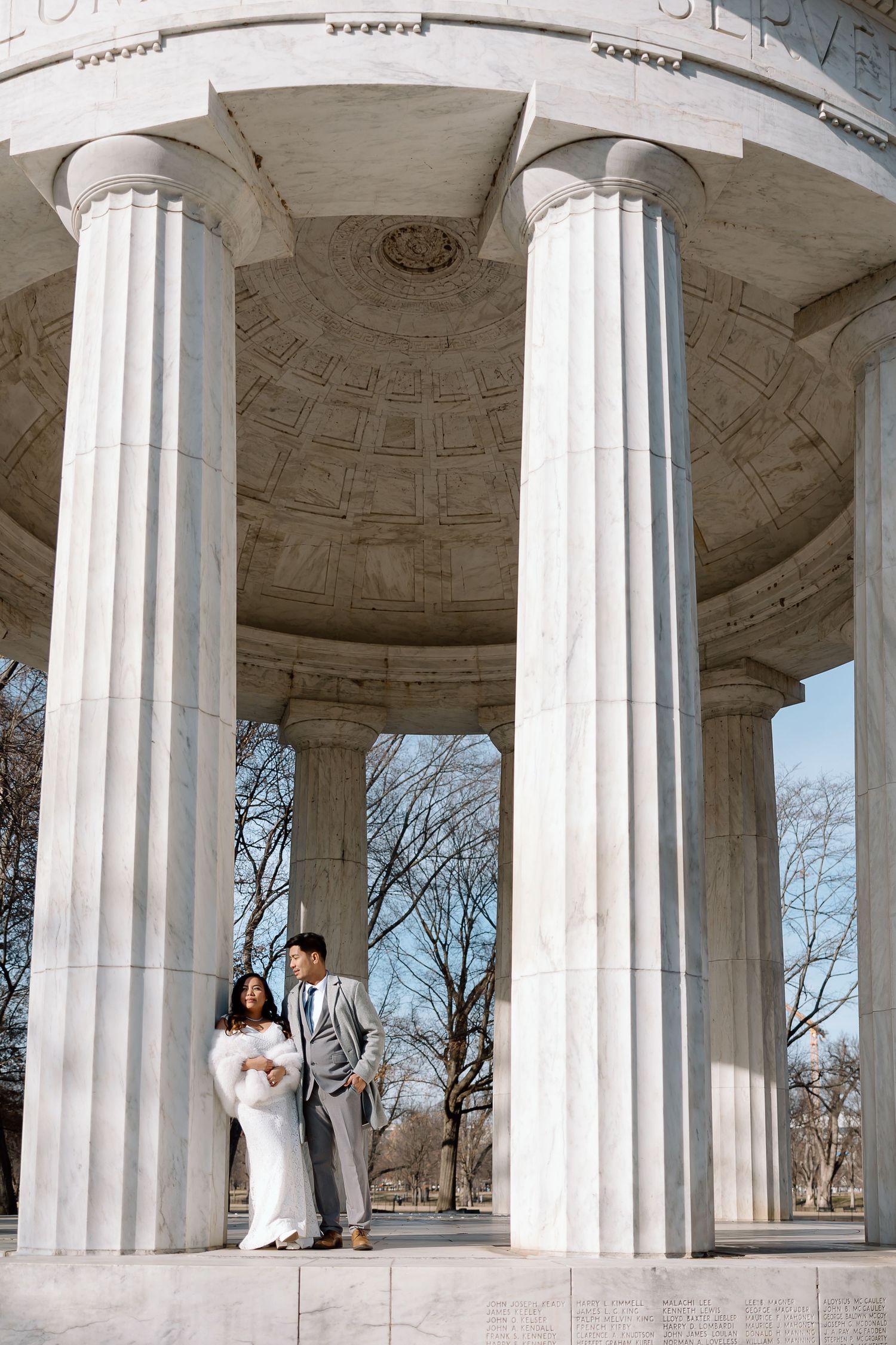 Candid newlywed moment captured at the DC War Memorial during a National Mall elopement.