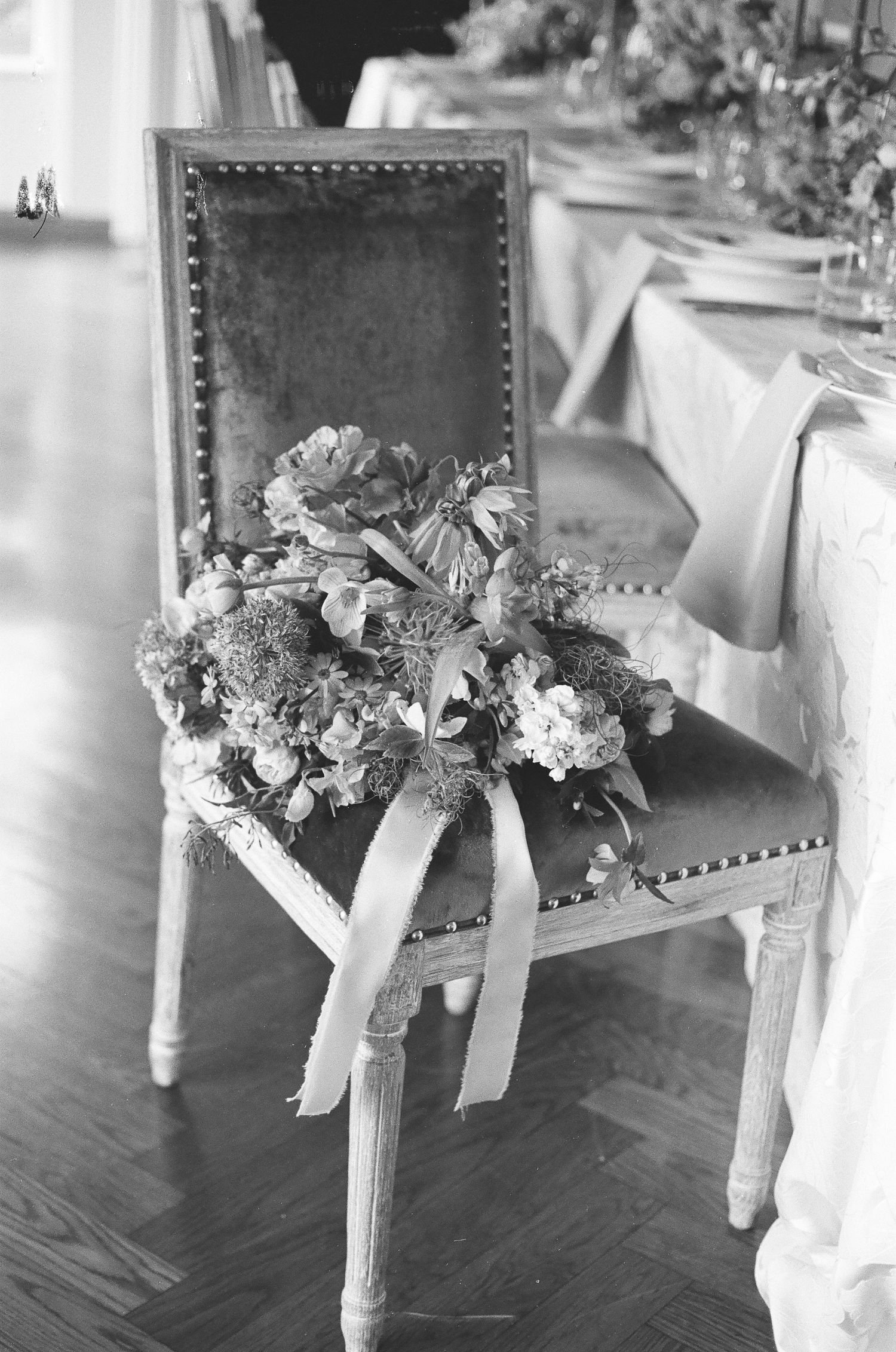 Candid reception moment shot on 35mm film with authentic lighting and texture