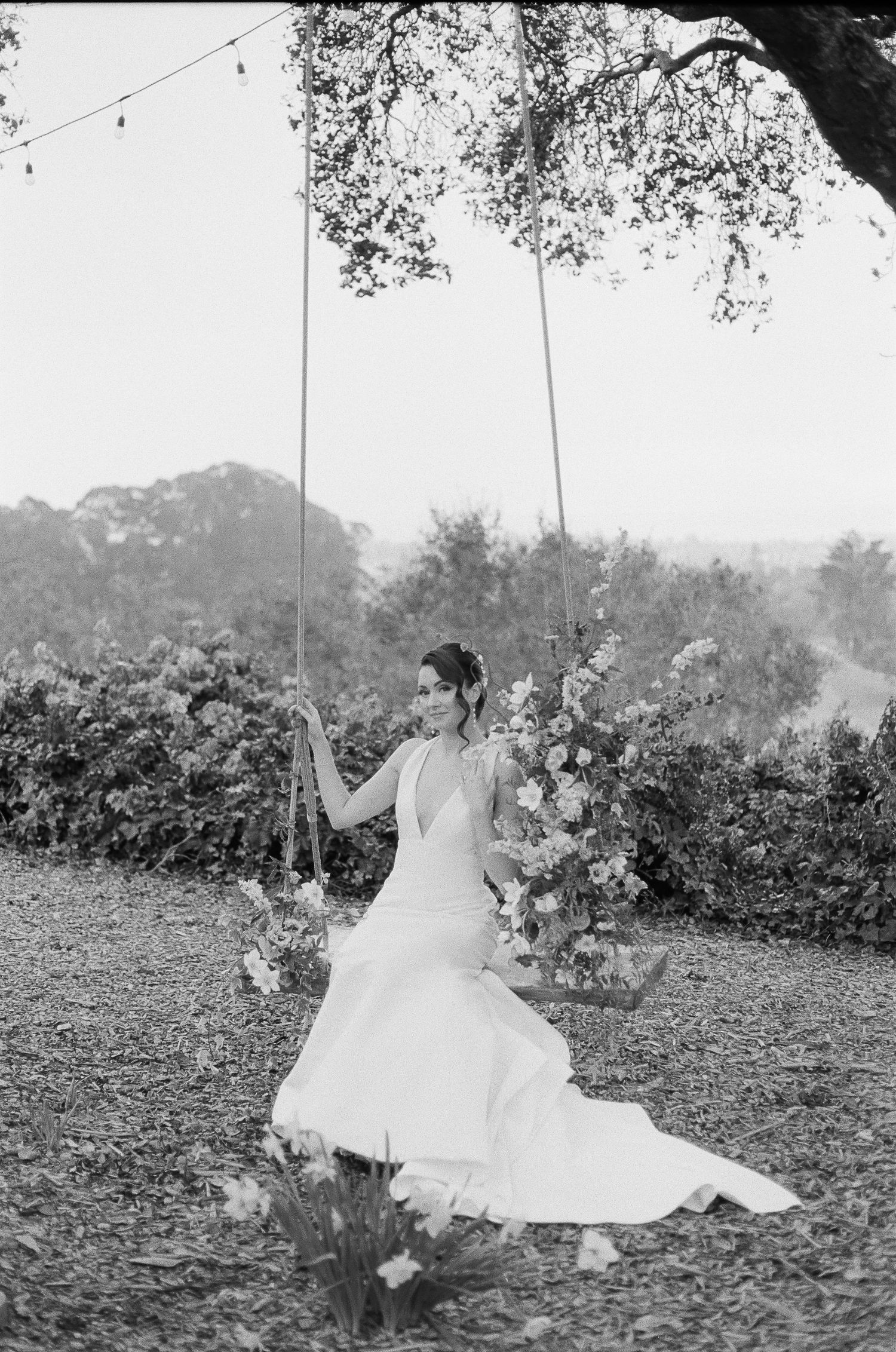 35mm film shot of bride stepping into her wedding dress with natural grain and texture