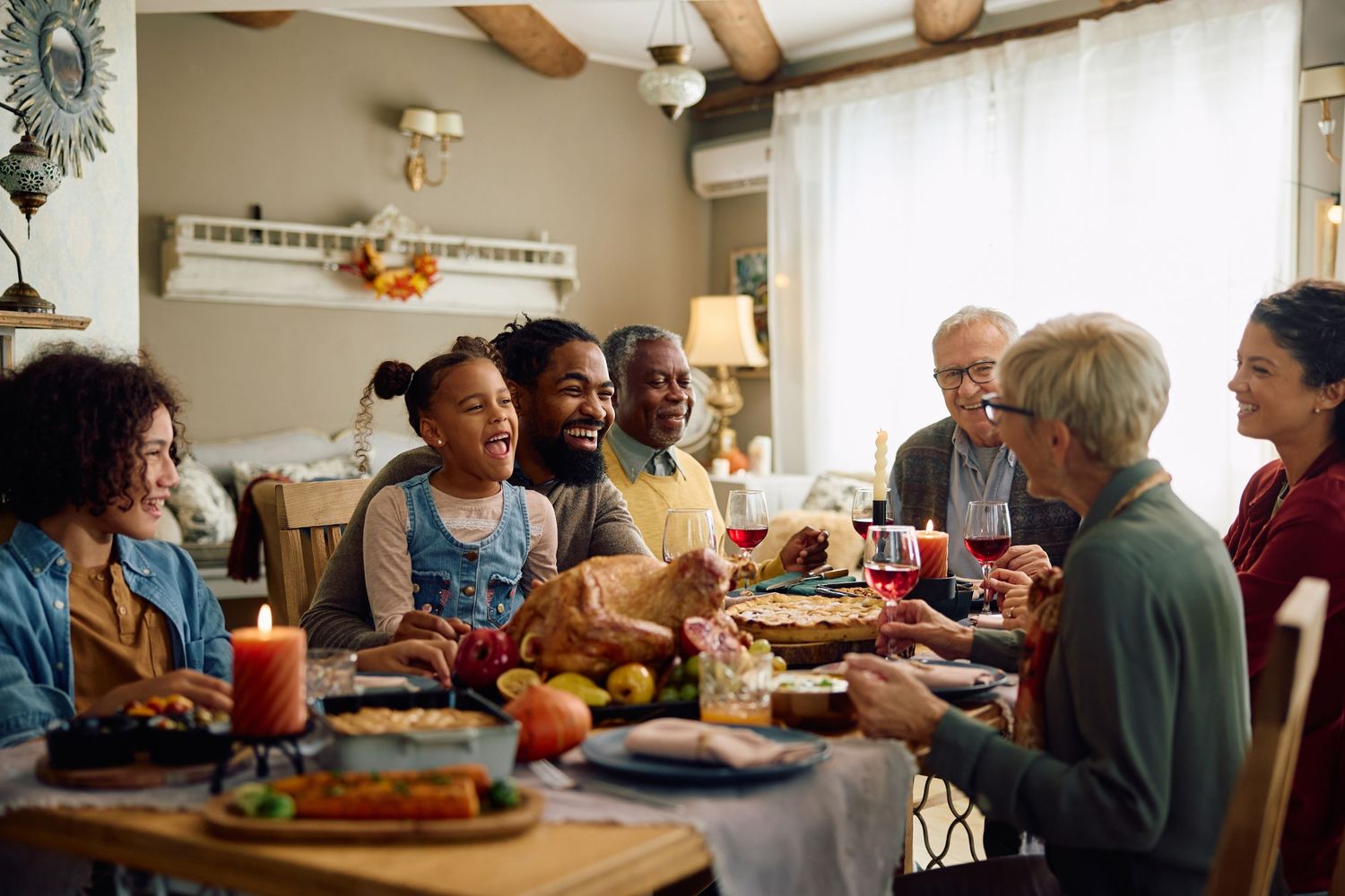 Multigenerational family sharing a festive Thanksgiving dinner together at a beautifully decorated table.