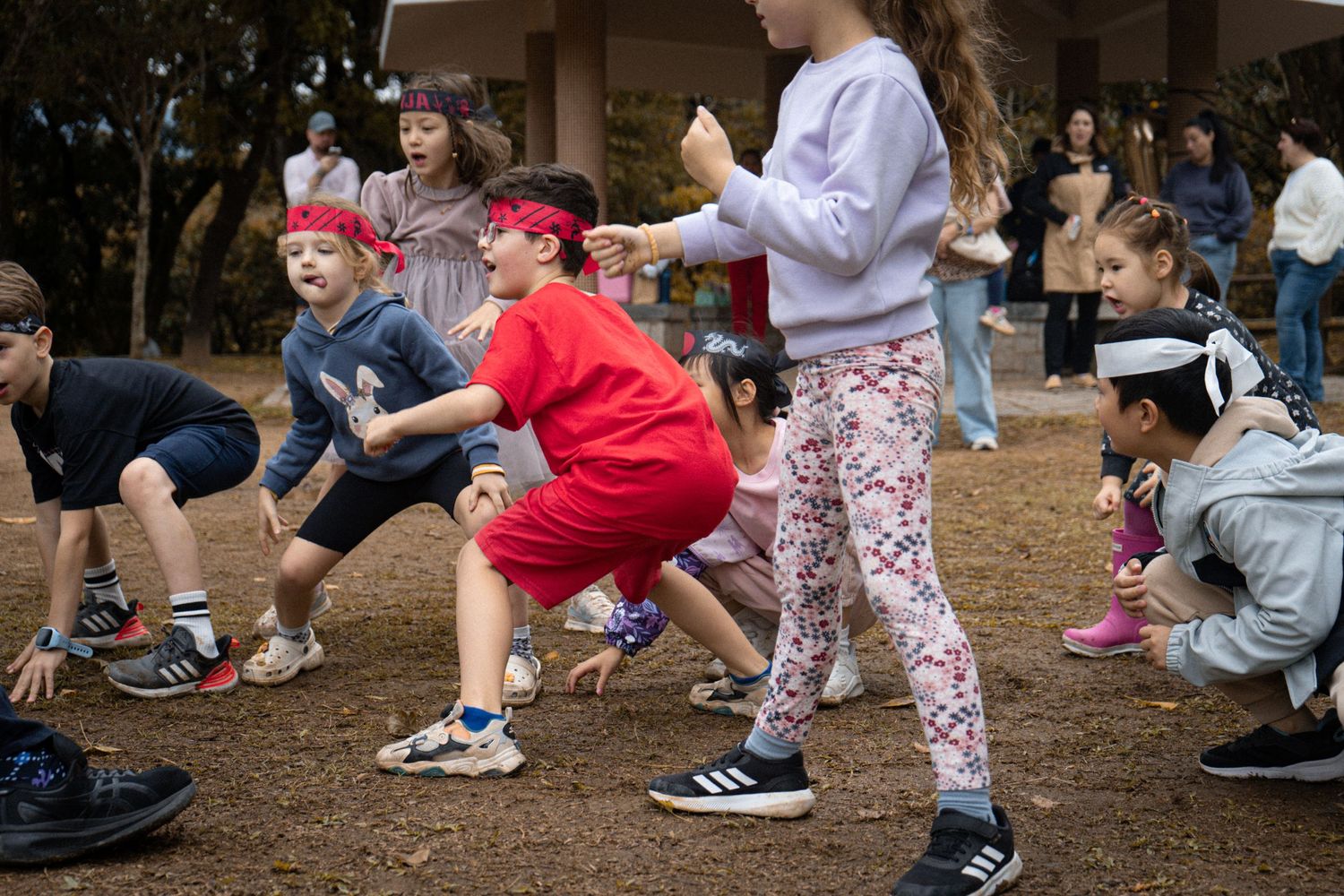 Participants in athletic poses during outdoor group exercise activity.