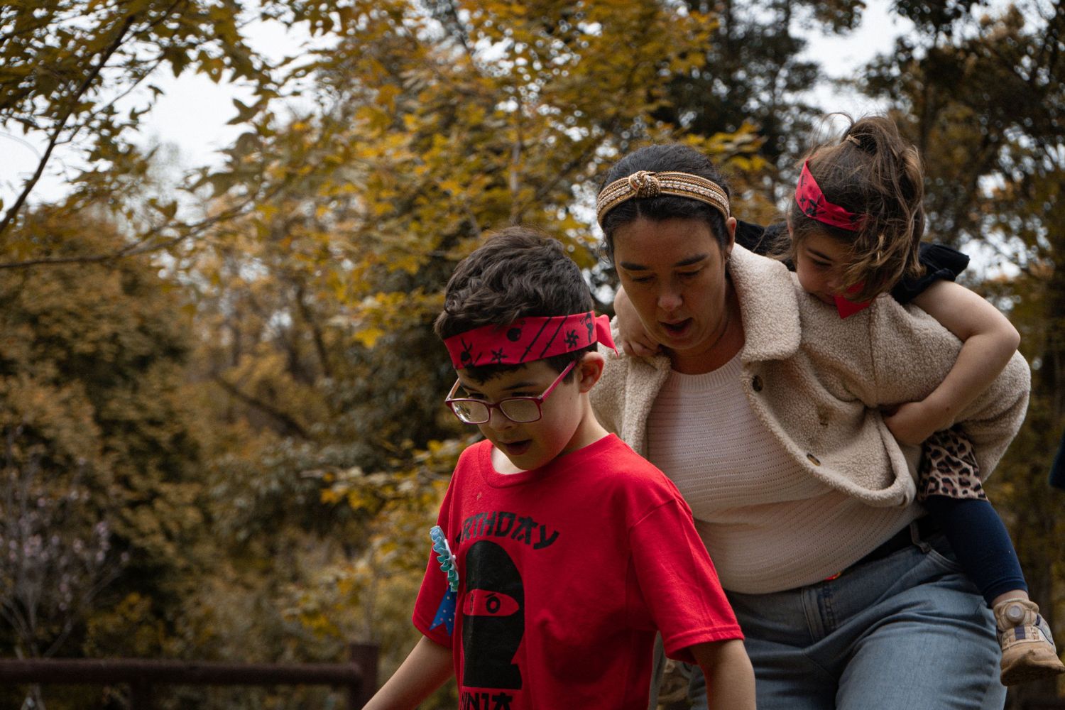 Group engaged in playful outdoor activities wearing colorful bandanas and casual attire.