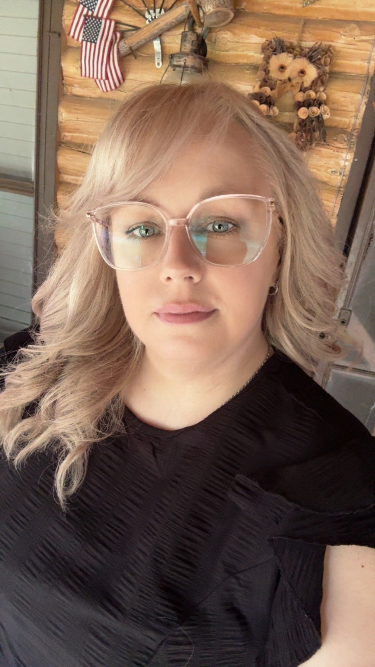 Close-up selfie series showing someone wearing glasses and a black top with American flags visible in the background.