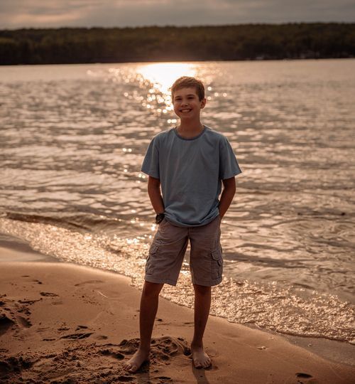 Sunset beach portrait with sparkling water and warm golden light.