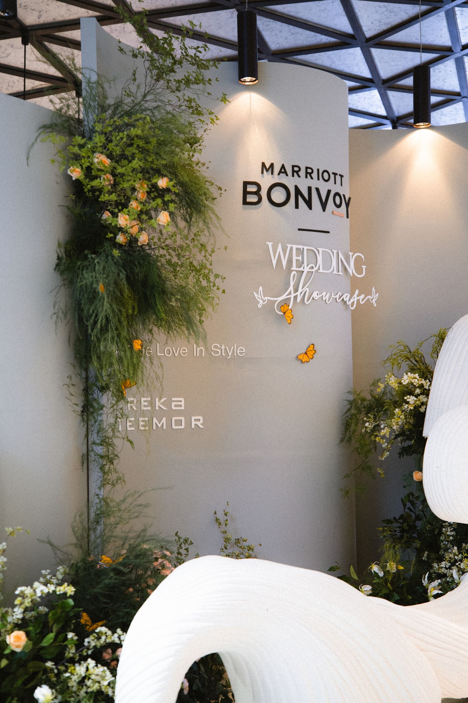 Marriott Bonvoy wedding showcase wall decorated with elegant floral arrangements and butterflies.