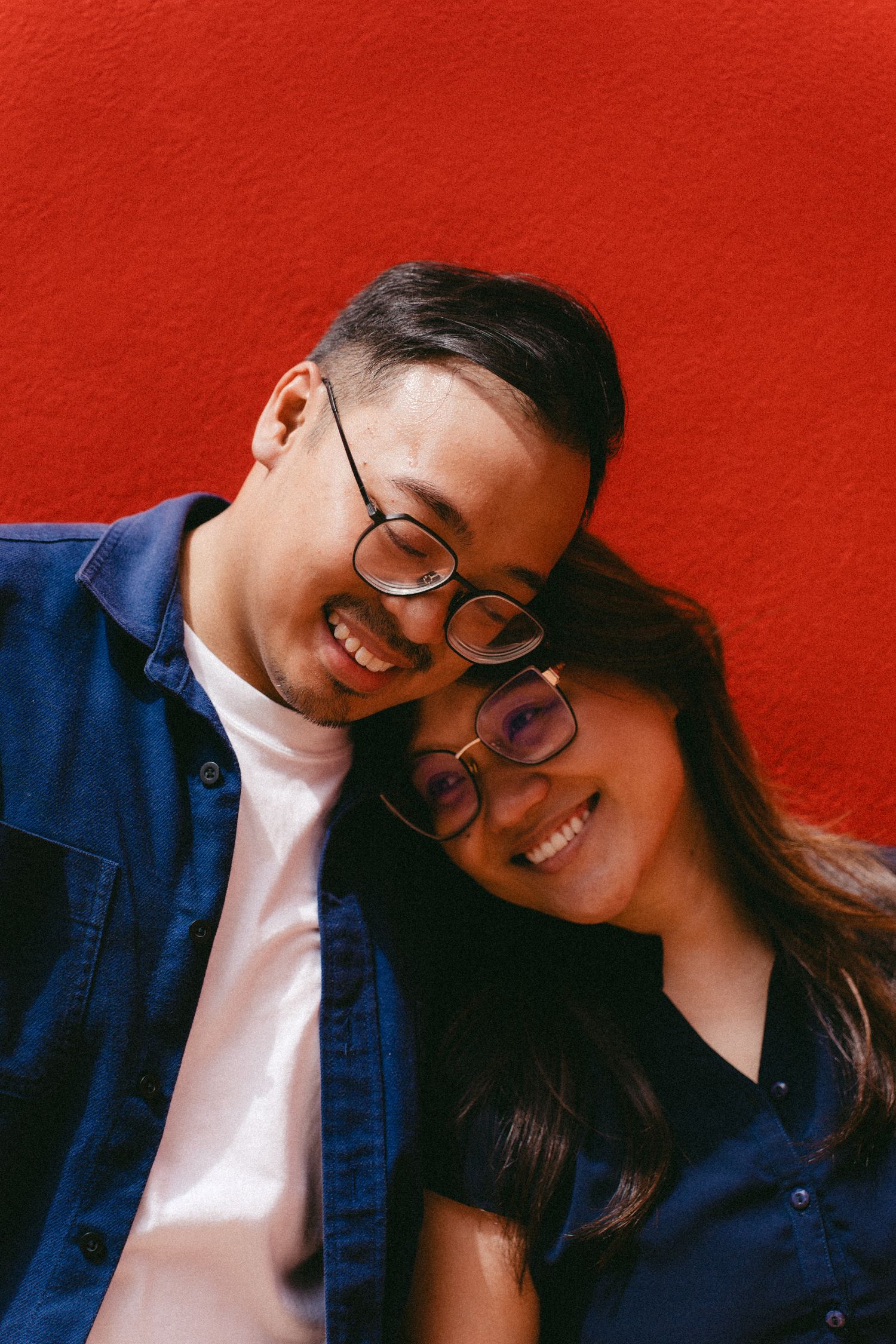 Several photos showing a couple in blue and white outfits posing together against a red background.