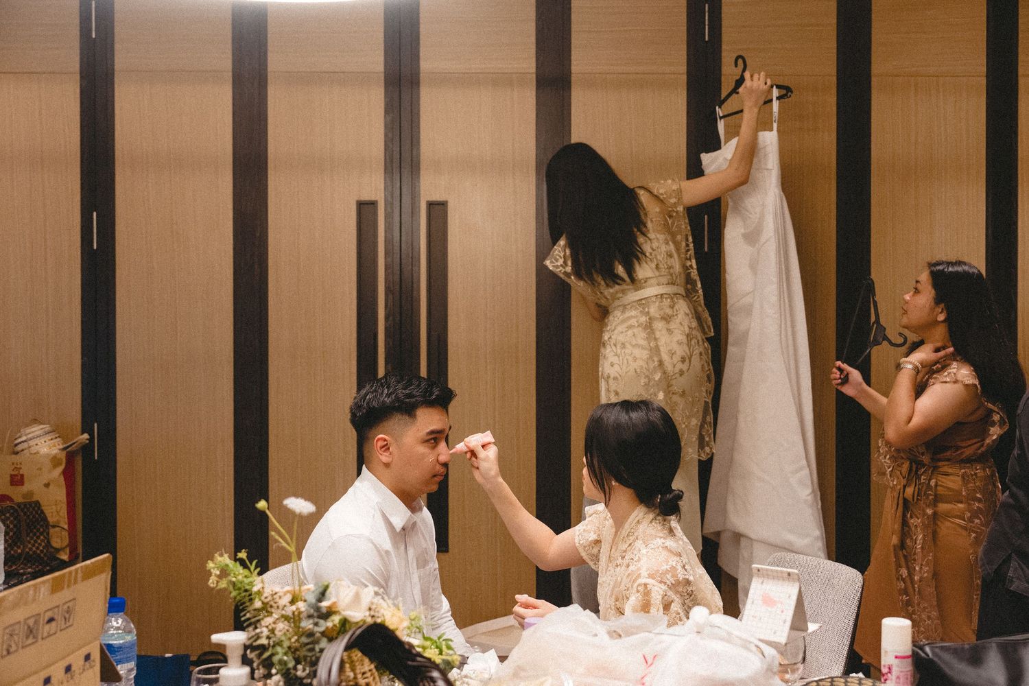 People celebrate during a festive indoor gathering with warm lighting and decorative elements at a special event.