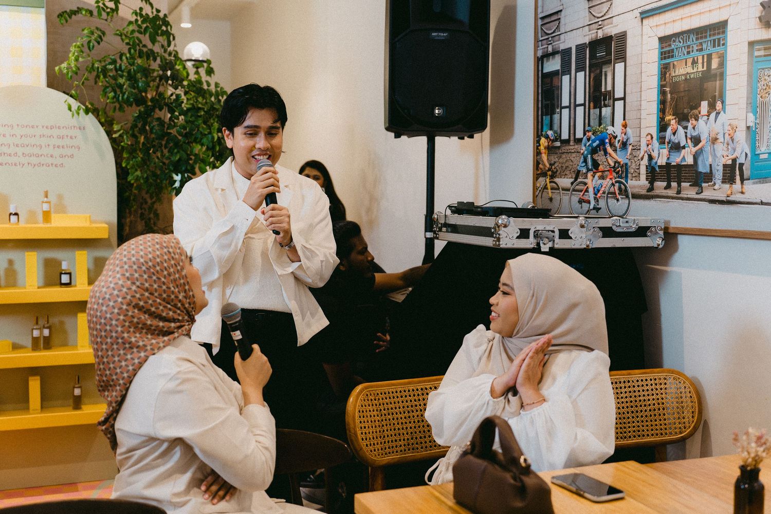 People engaged in conversation at a social gathering in a modern cafe.