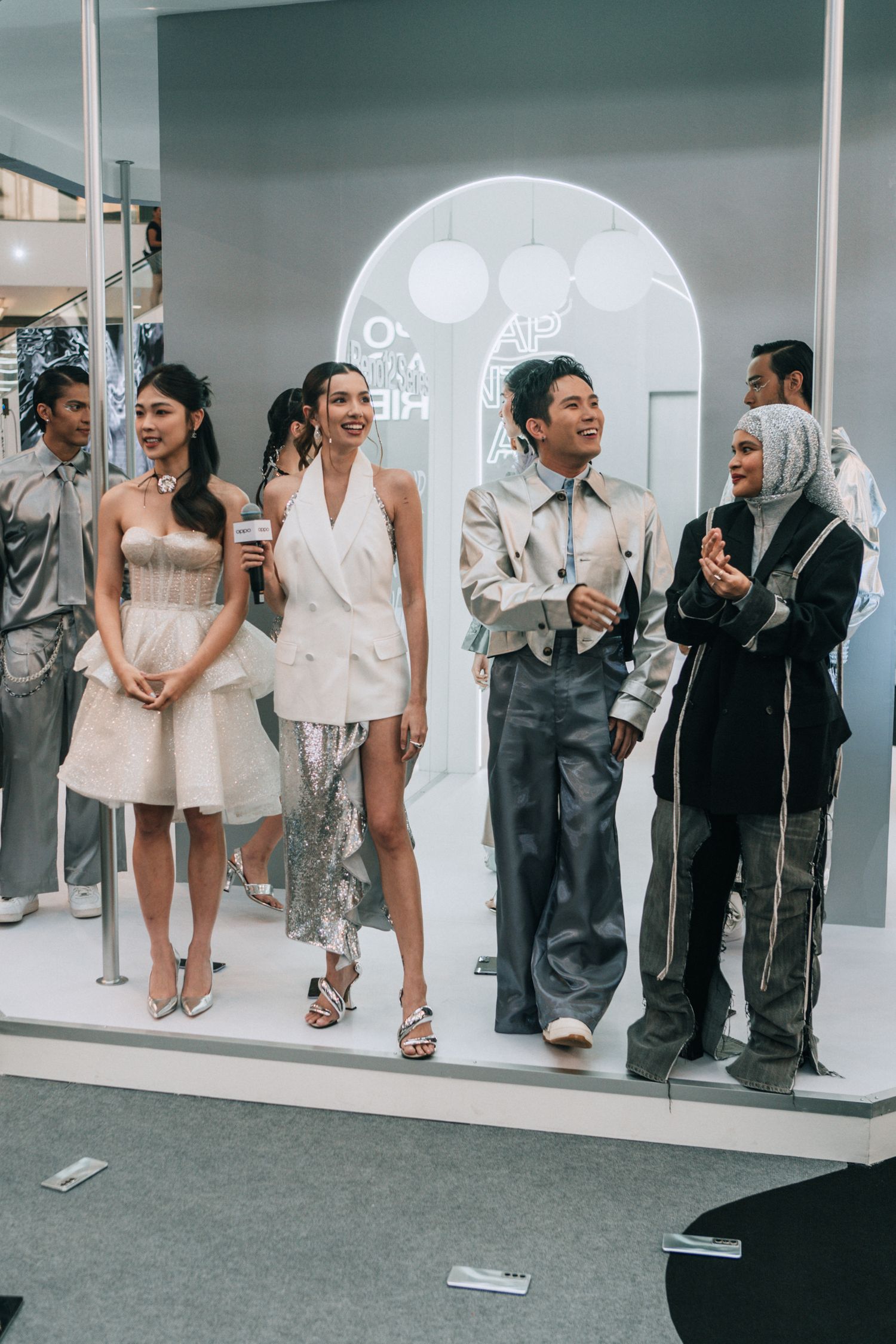 Fashion models showcase diverse styles against a minimalist white archway backdrop.