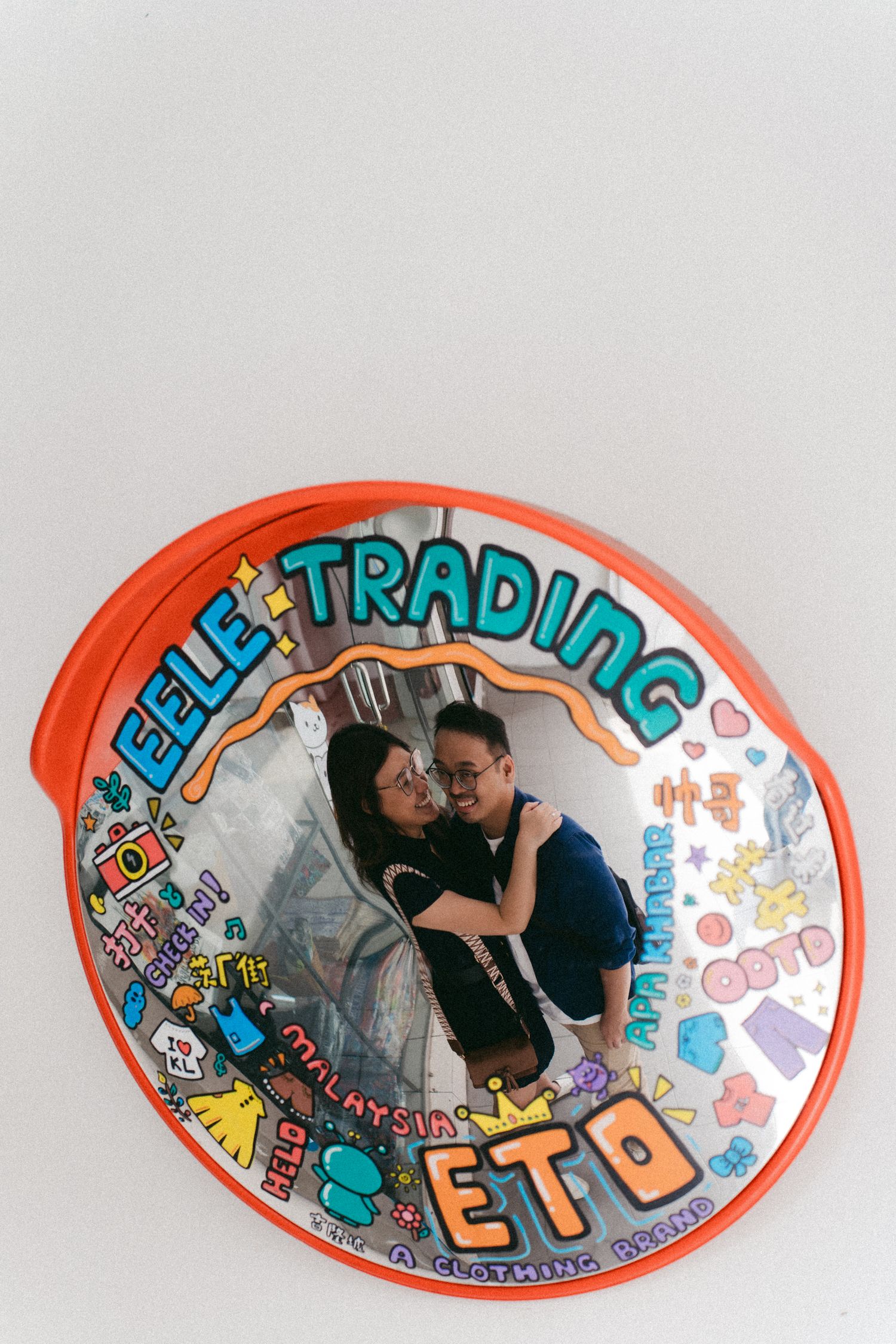 A series of oval-shaped artwork or stickers with colorful text and designs against a light background.