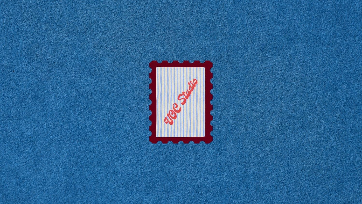A decorative postage stamp with red borders on blue fabric, featuring cursive text and vertical stripes design.