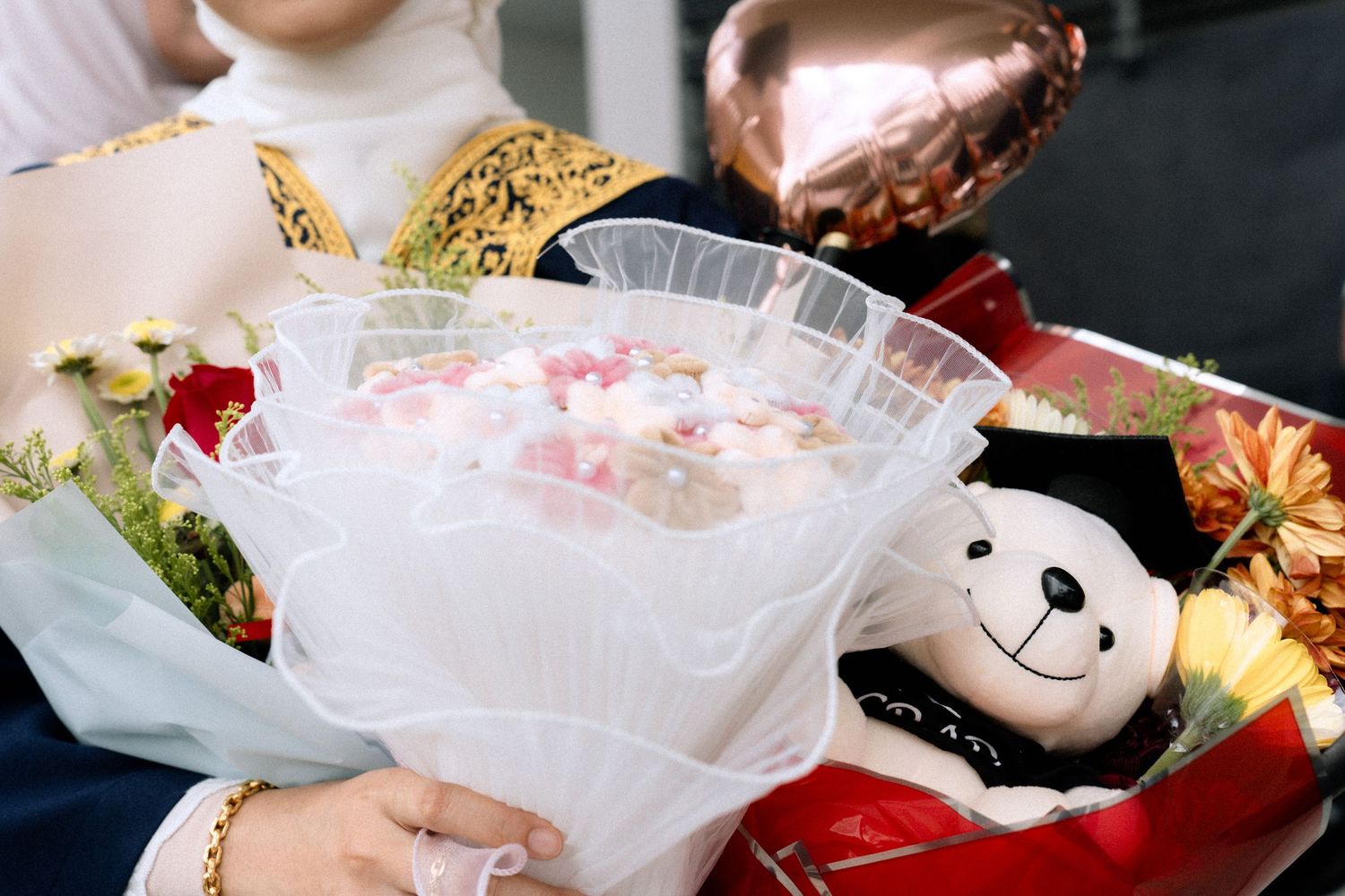 Festive dessert display featuring pink milkshakes decorated with cookies and whipped cream.