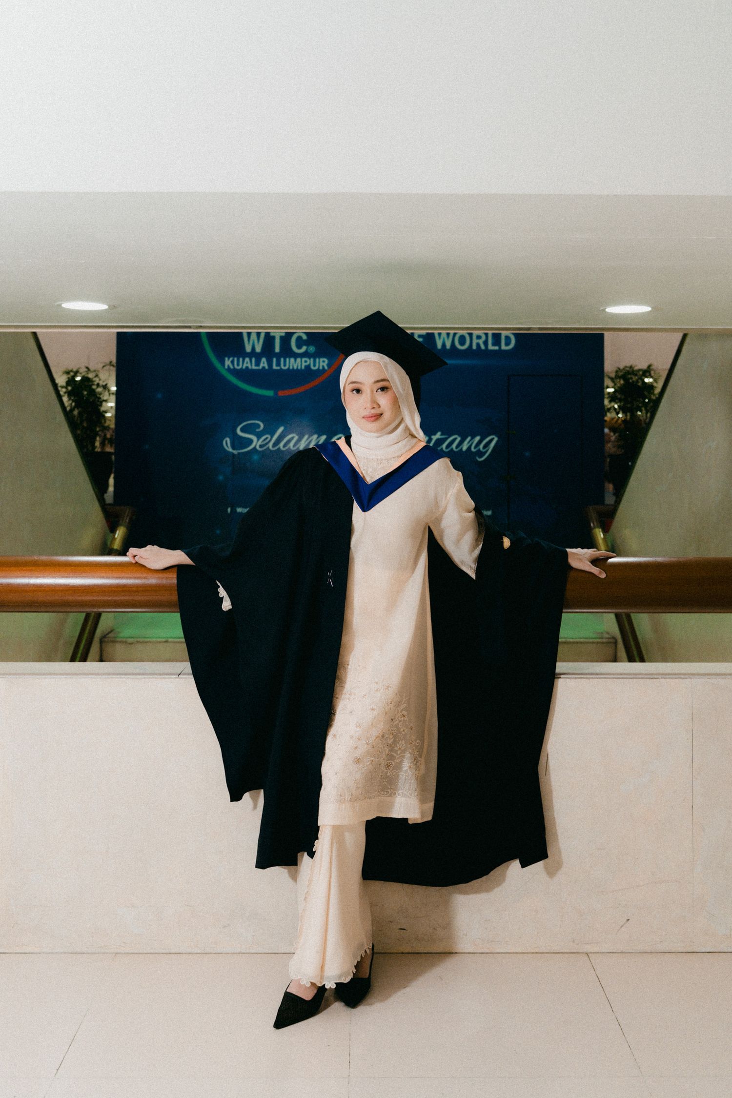 A sequence of photos showing a black abaya and white dress displayed on hangers against a light-colored wall.