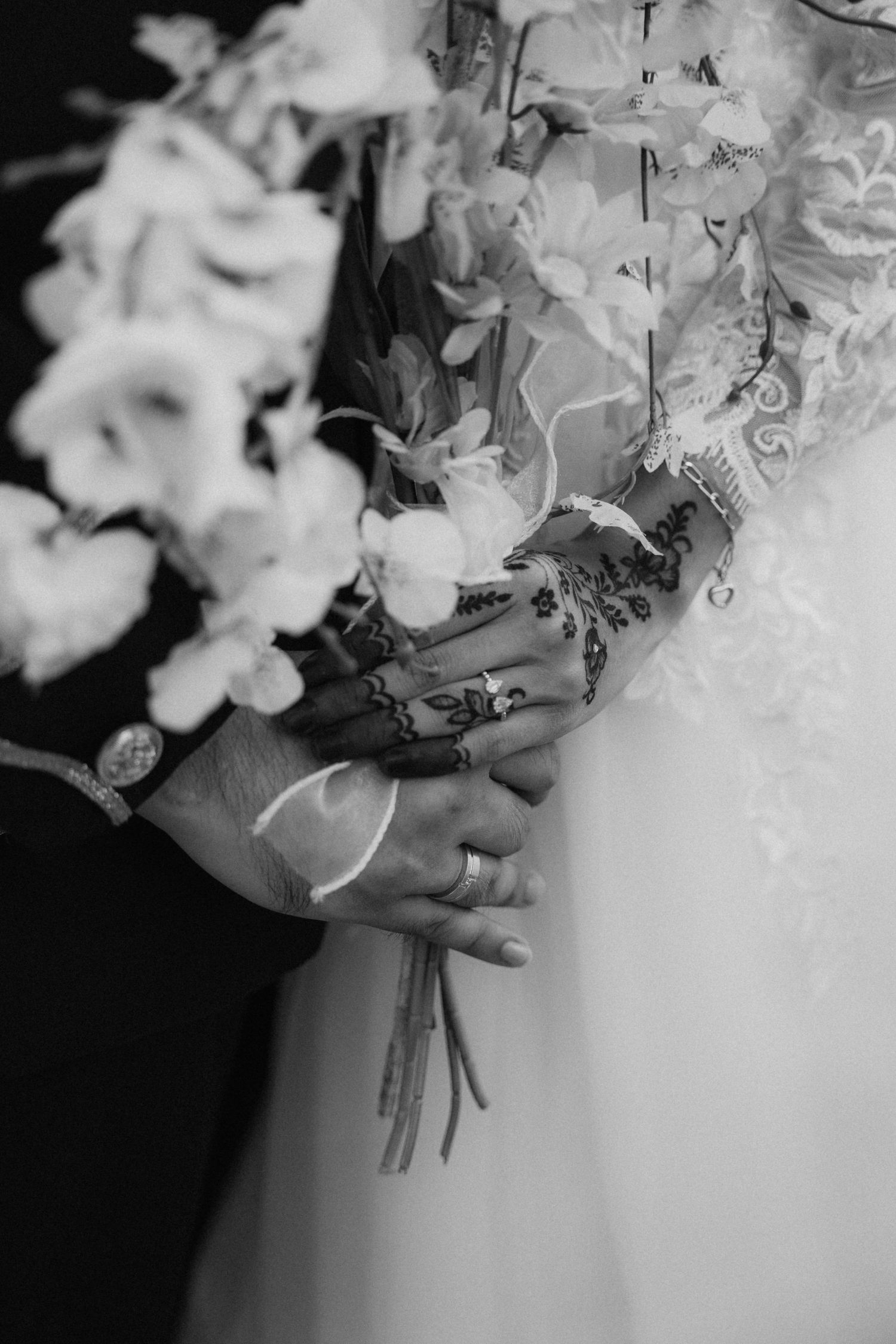 A black and white image shows white hydrangea flowers in full bloom arranged in a wedding bouquet.