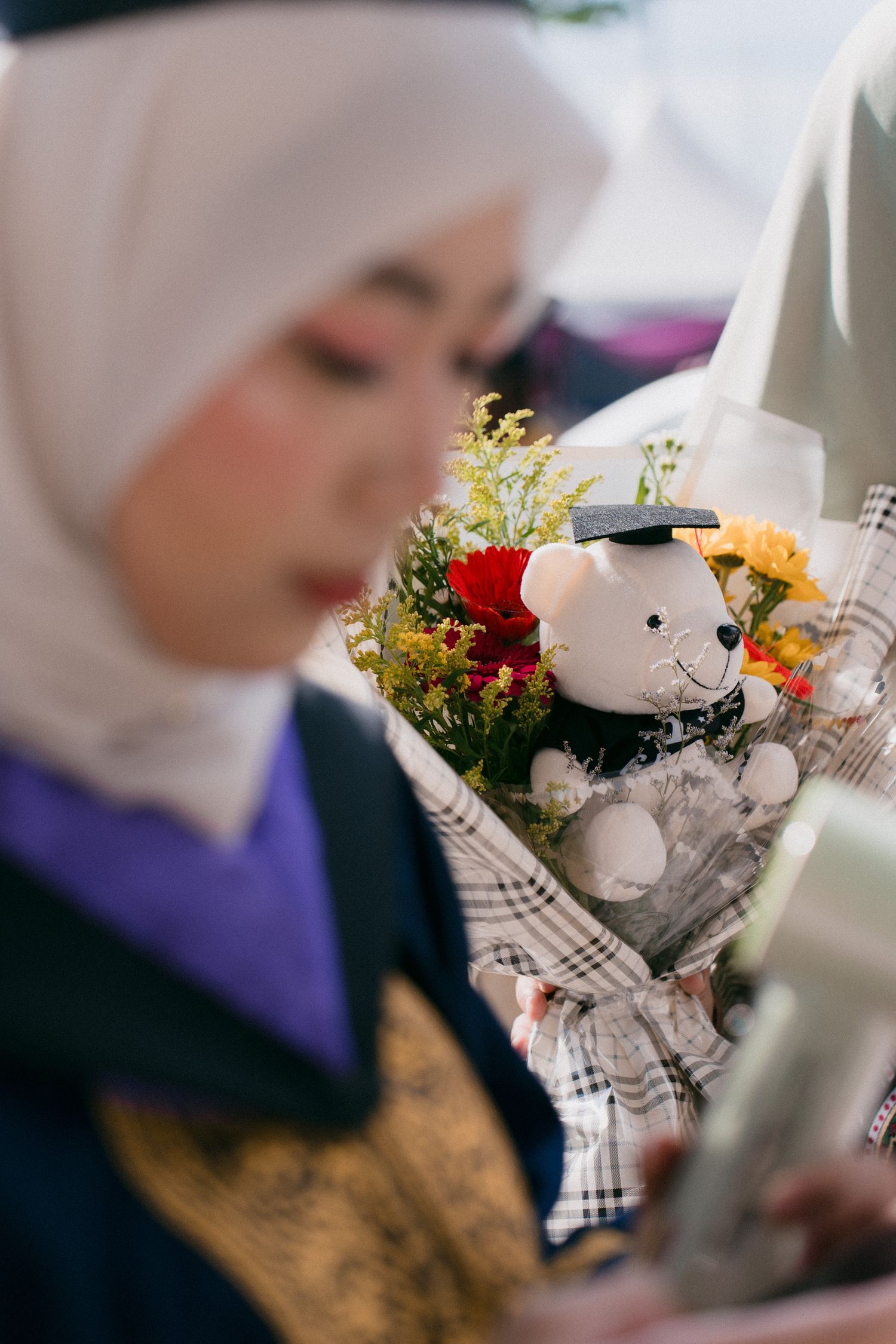A series of blurred images showing floral arrangements with white and colorful flowers against a soft background.