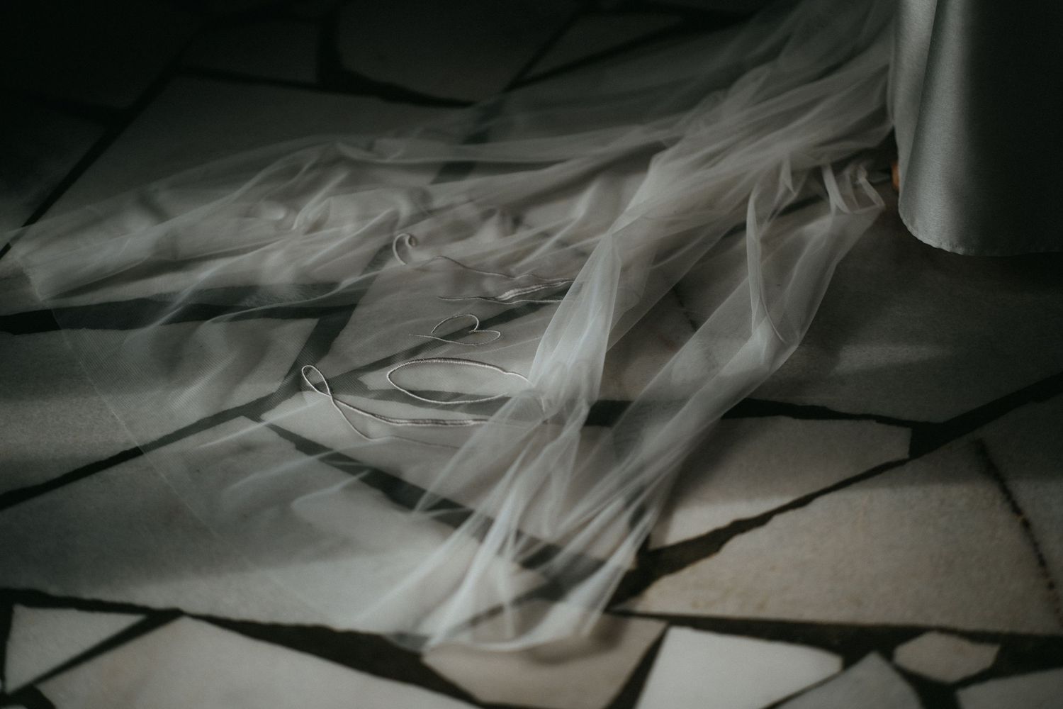 Legal documents and paperwork are scattered across a wooden desk showing files in disarray and unorganized chaos.