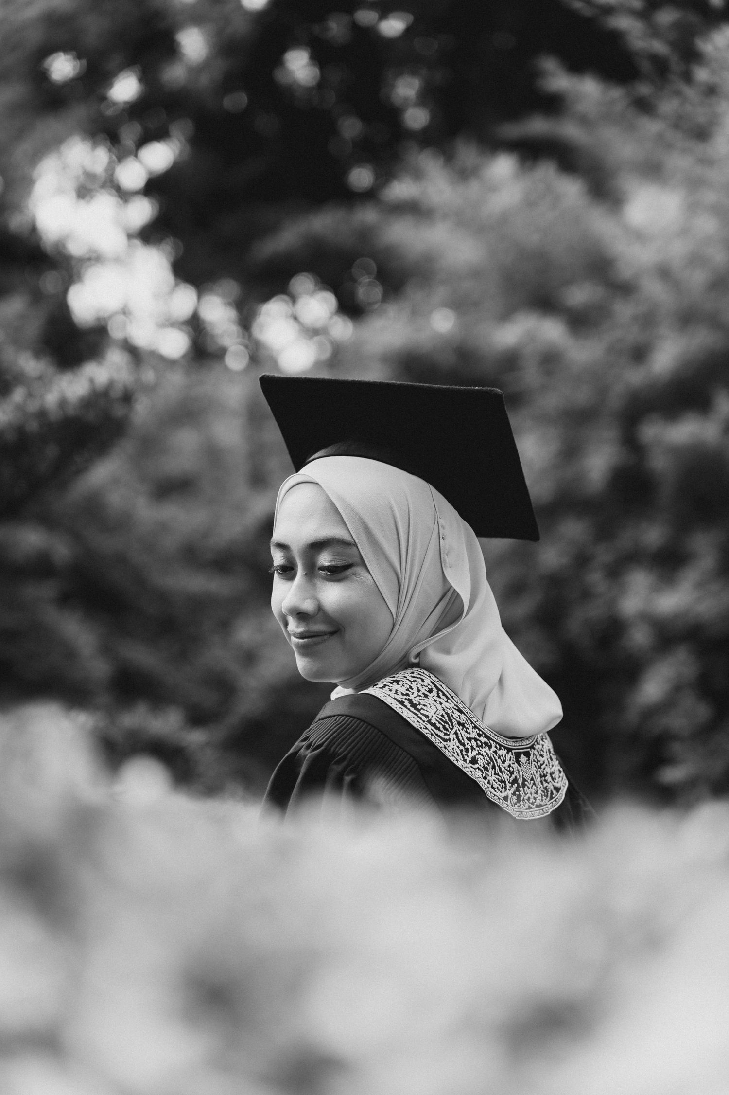 Black and white portrait series showing profile views with elegant white hijab against soft bokeh background.