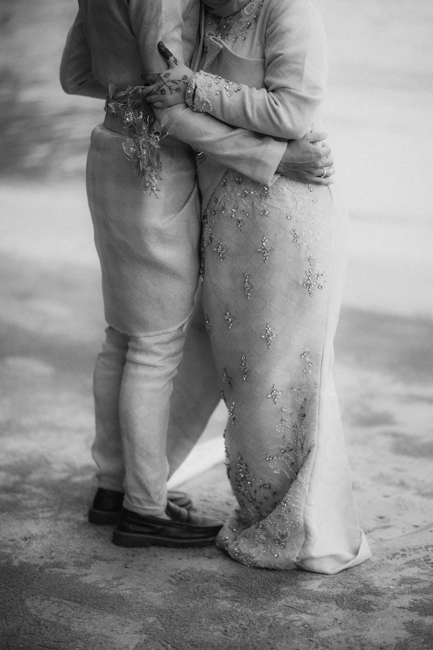 Black and white close-up photographs showing toddler legs and feet embracing in a repeated sequence of tender moments.