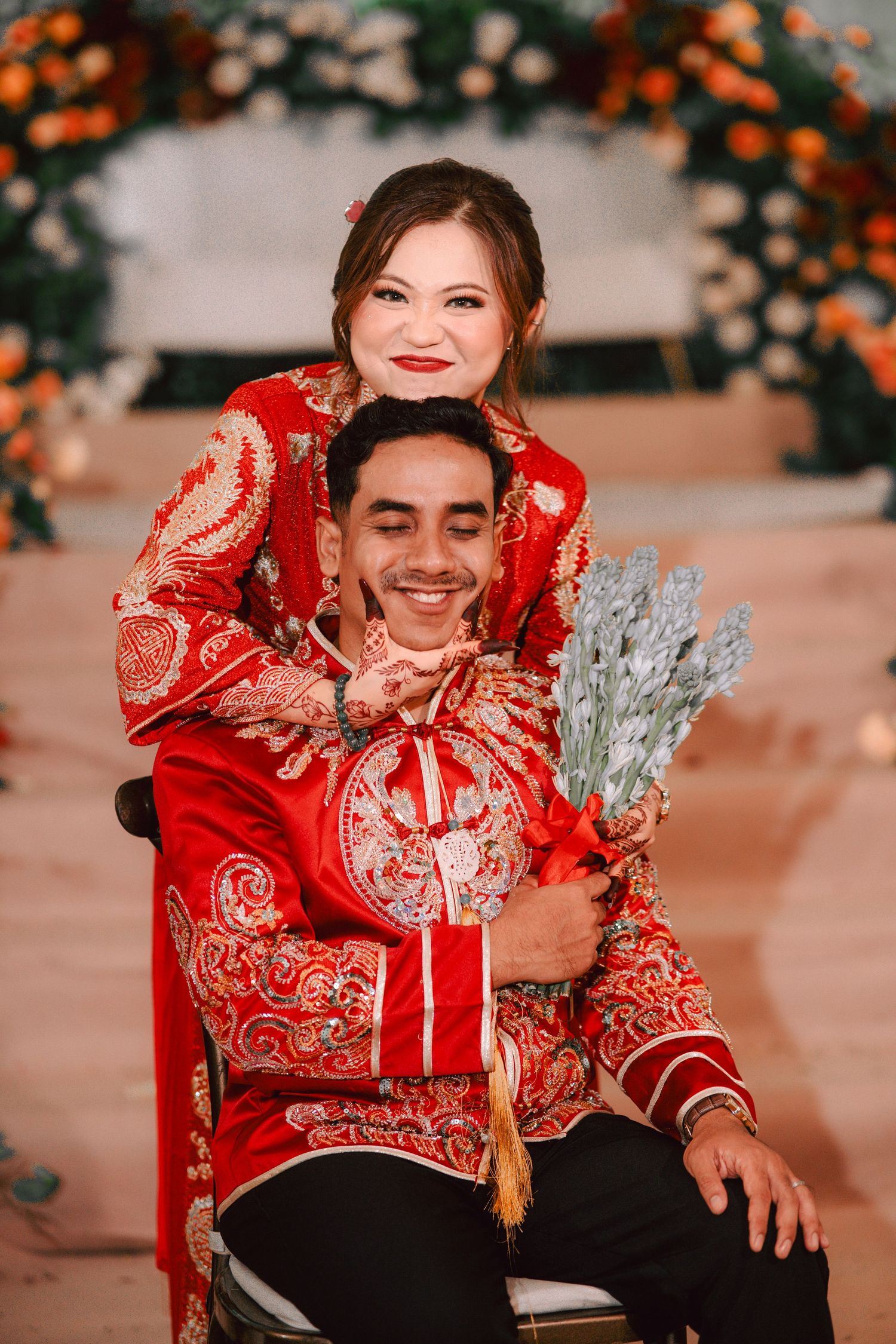 A photo series in traditional red Chinese wedding attire with decorative floral elements in orange and silver tones.
