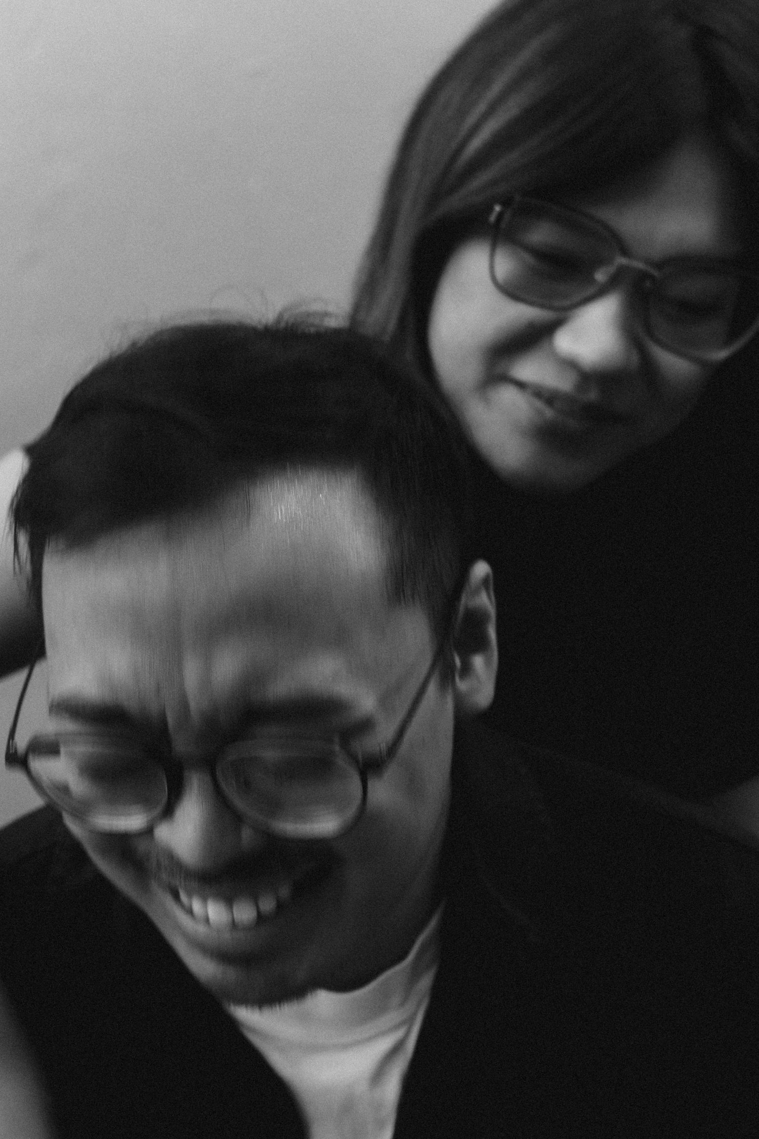 Black and white portrait series showing a person with glasses expressing different emotions and reactions.