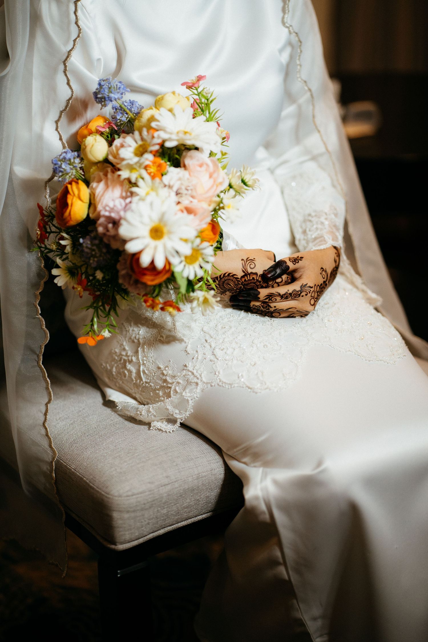 Close-up series of vintage white lace wedding boots decorated with fresh colorful spring flowers and delicate details.