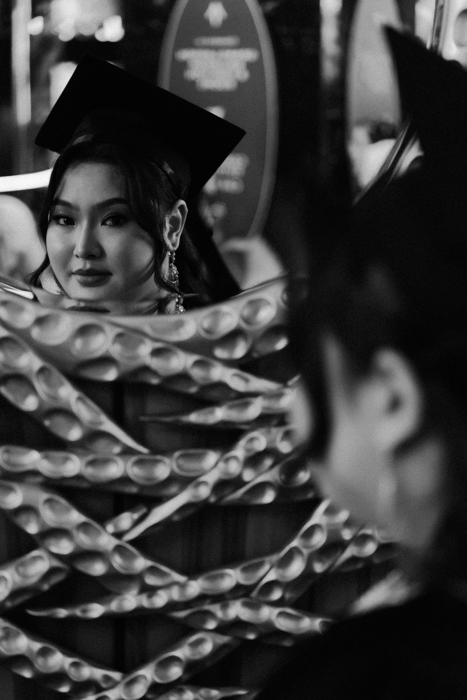 A black and white artistic portrait showing a silhouette through a pattern of circular geometric shapes.