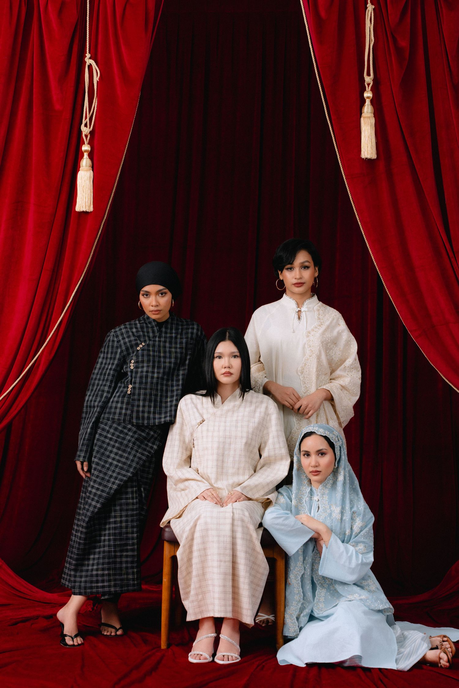 A series of four artistic portraits against dramatic red velvet curtains showing people in casual and traditional attire.
