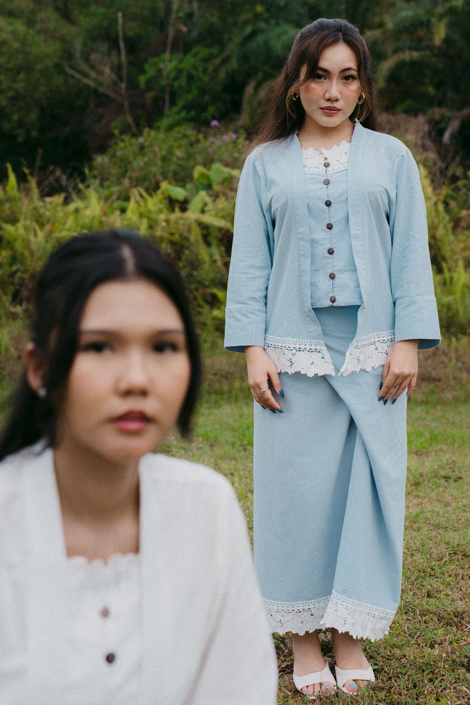 Fashion photo of models in light blue and white lace-trimmed coordinated outfits.