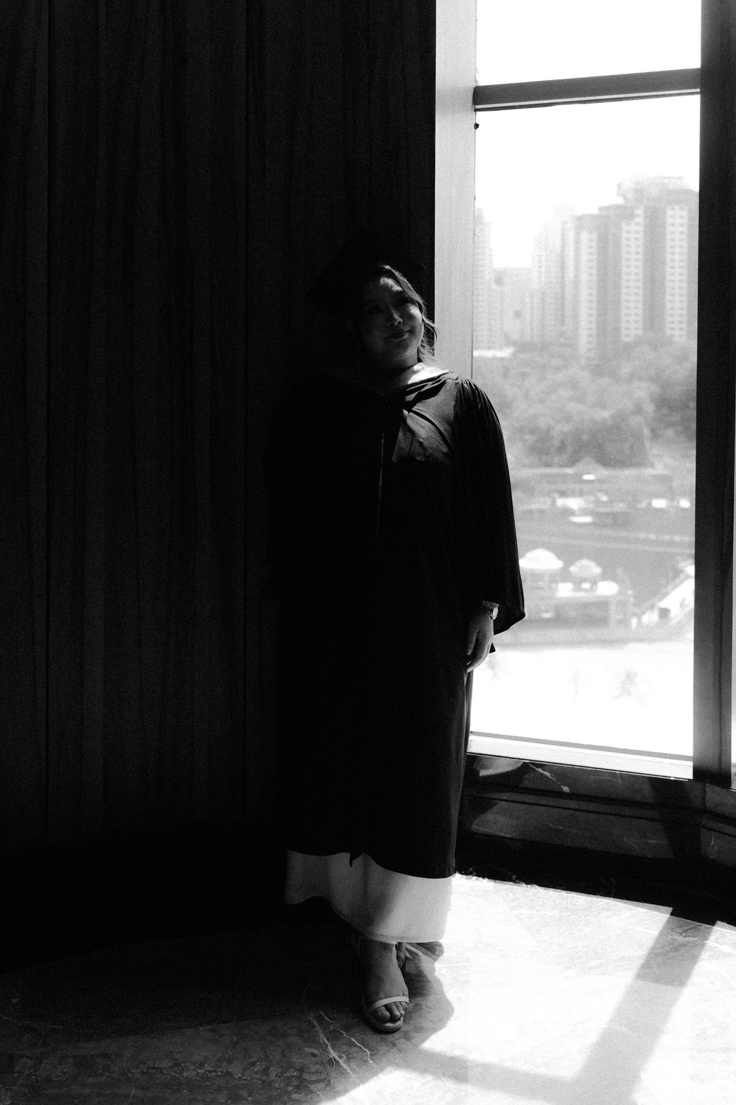 Black and white silhouette of window frames casting dramatic shadows in a modern interior space.