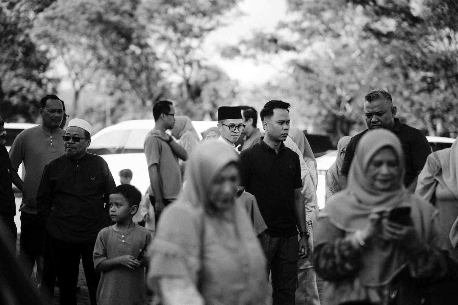Black and white candid shots of guests mingling at an outdoor event.