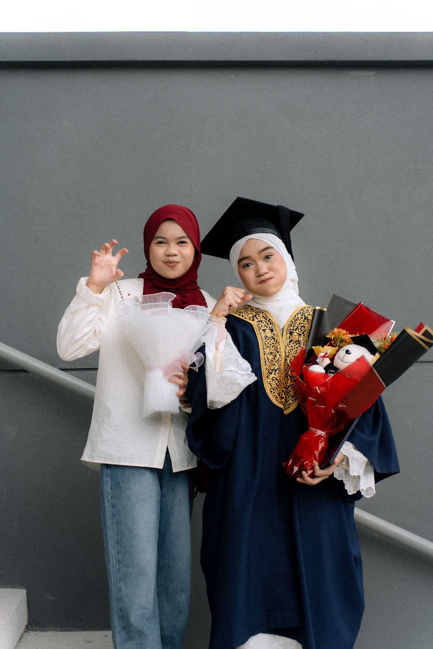 Graduation photo series showing graduates in navy gowns and casual attire posing with red flowers and diplomas.