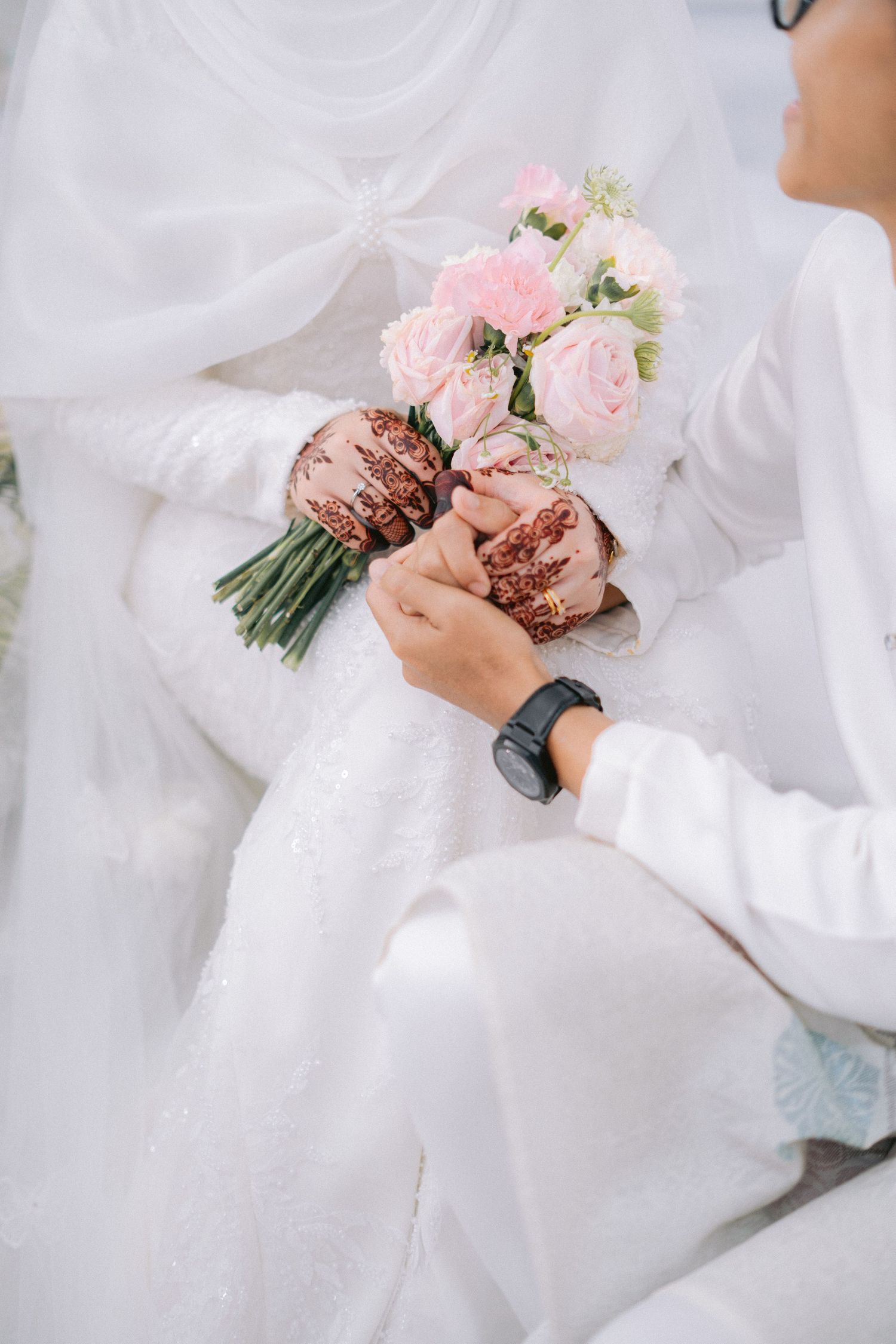 A close-up series showing delicate pink roses in bouquet form against soft white fabric in a dreamy wedding setting.